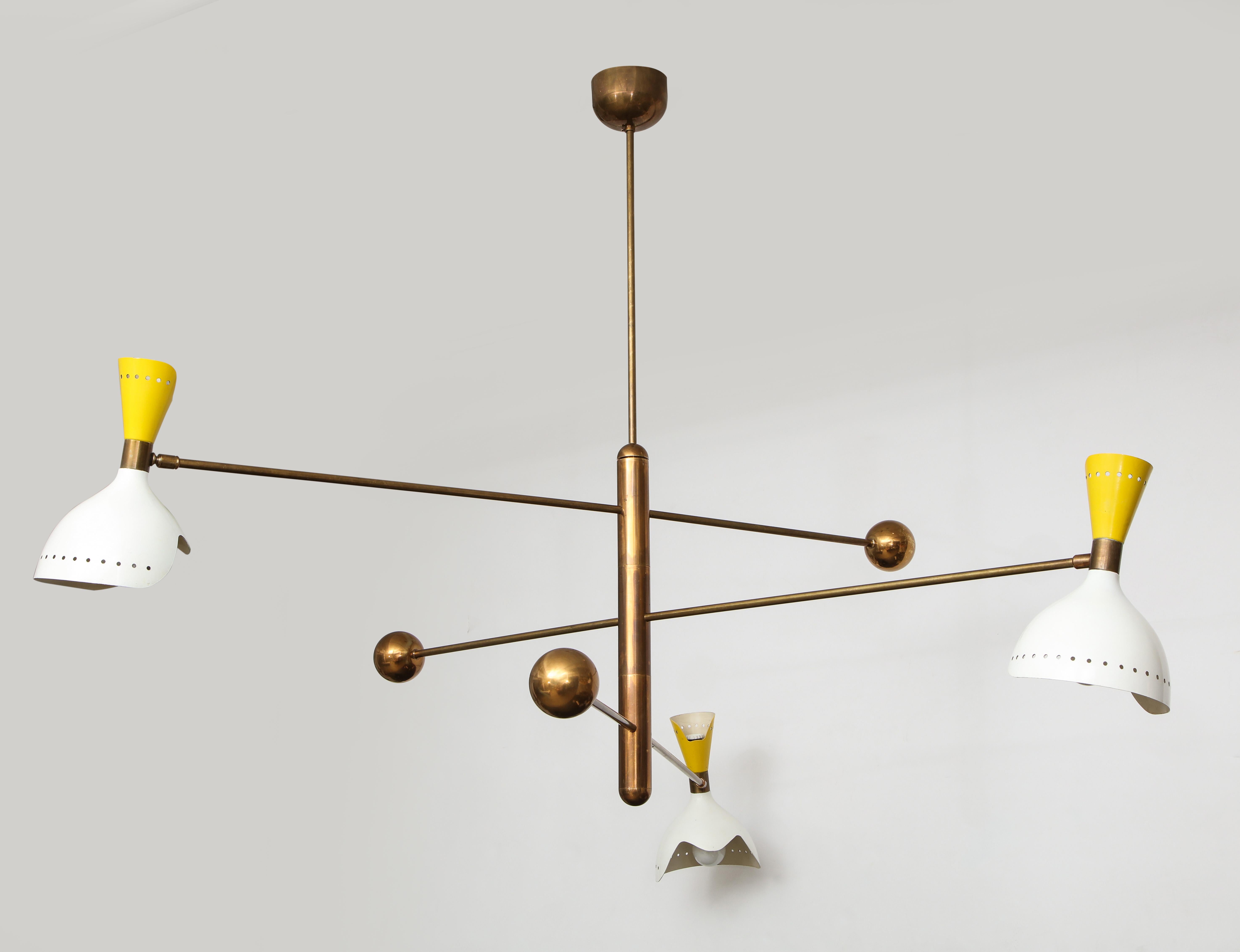 Stilnovo rare three-arm mobile chandelier suspended from brass structure and canopy, Italy, circa 1960. This hanging light fixture has rotating arms with curvaceous double cutout aluminum shades in lacquered white and yellow enamel and brass