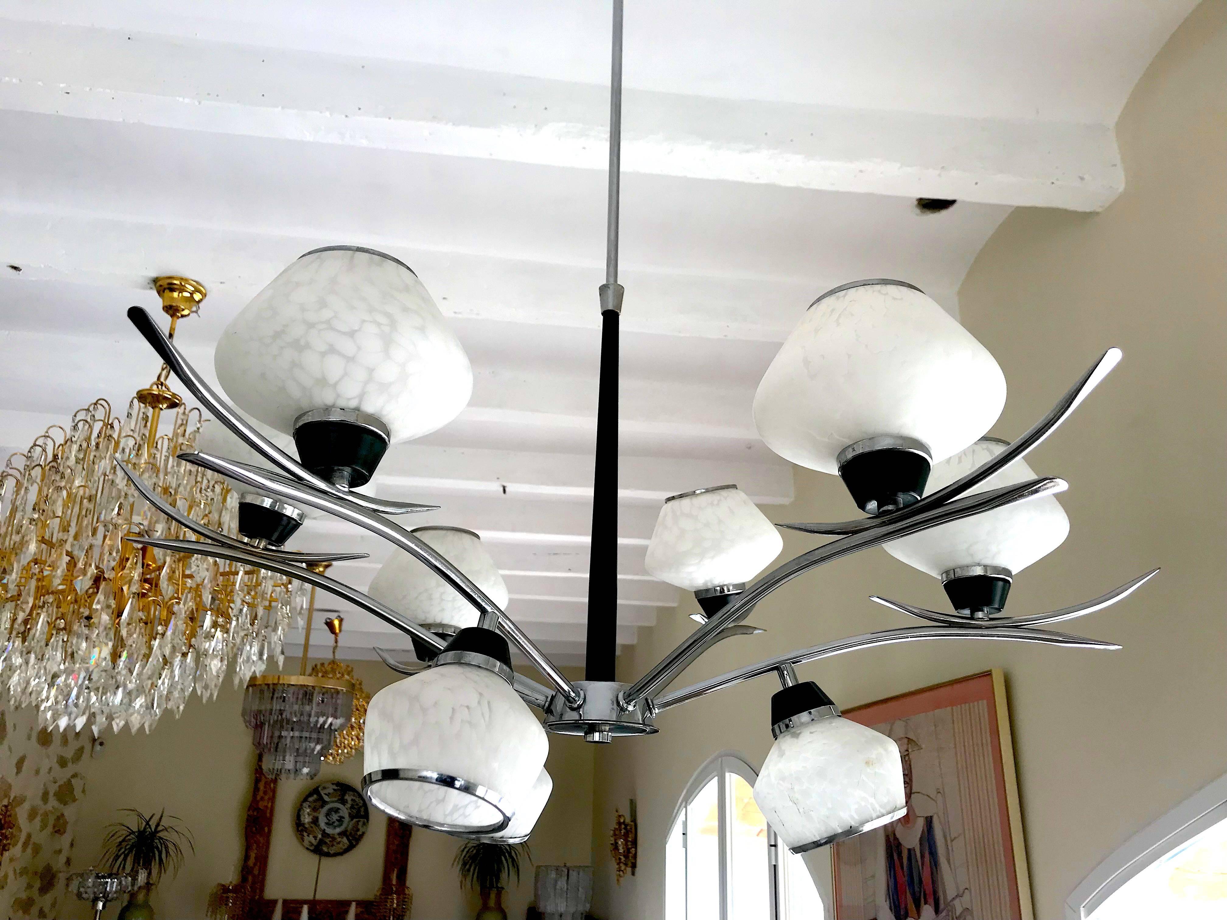Nine glass white smog, chrome brass chandelier from the seventies of Stilnovo. Well built and designed with arched brass arches that support elliptical brass mounts for glass spheres. Very fluide model.