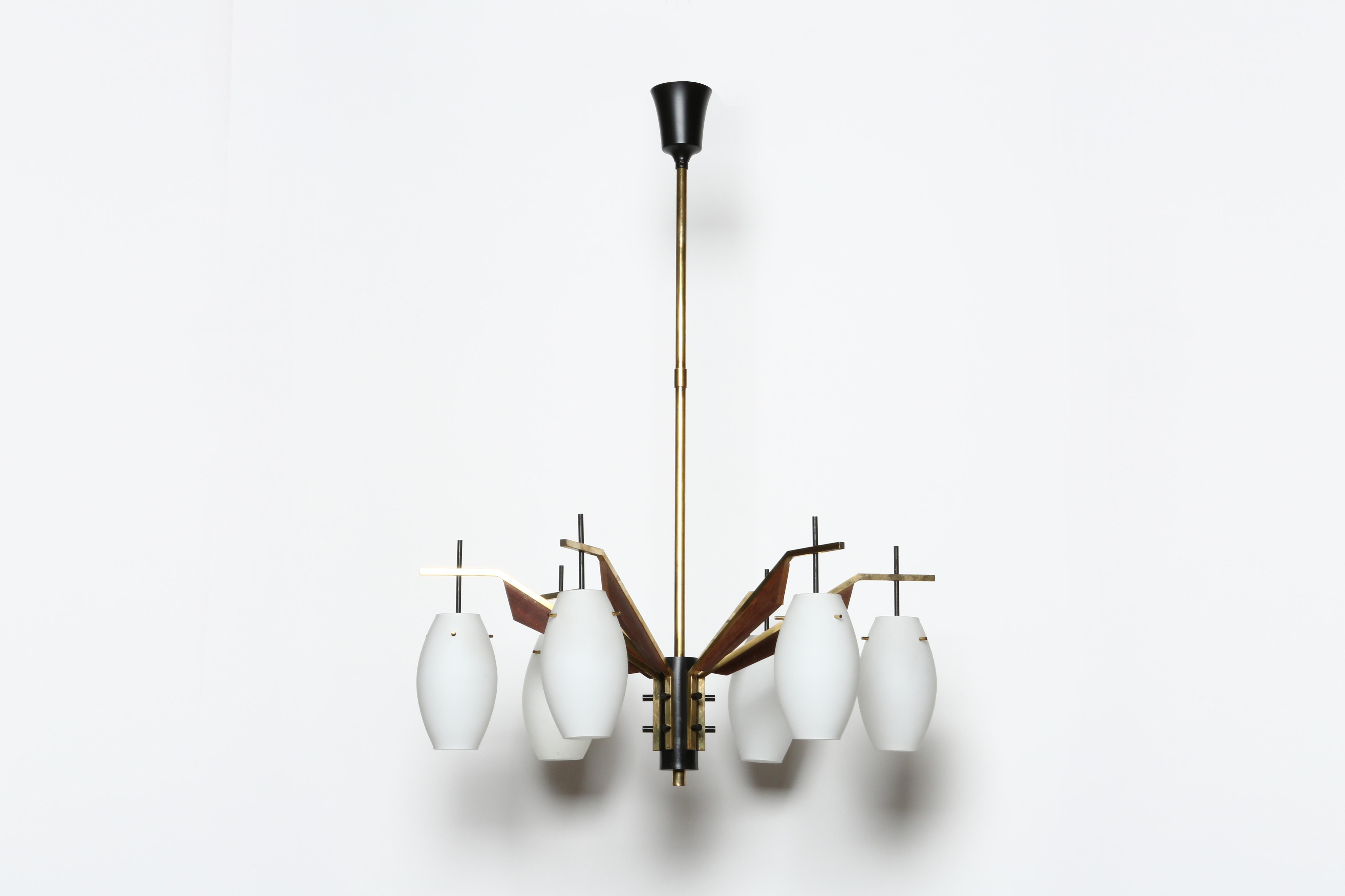 Stilnovo style chandelier.
Designed and made in Italy, 1960s.
Opaline glass, brass, wood, enameled metal.
Takes six candelabra bulbs.
Complimentary US rewiring upon request.
Height ( overall drop) is adjustable. Can be shorter or longer.
FREE US