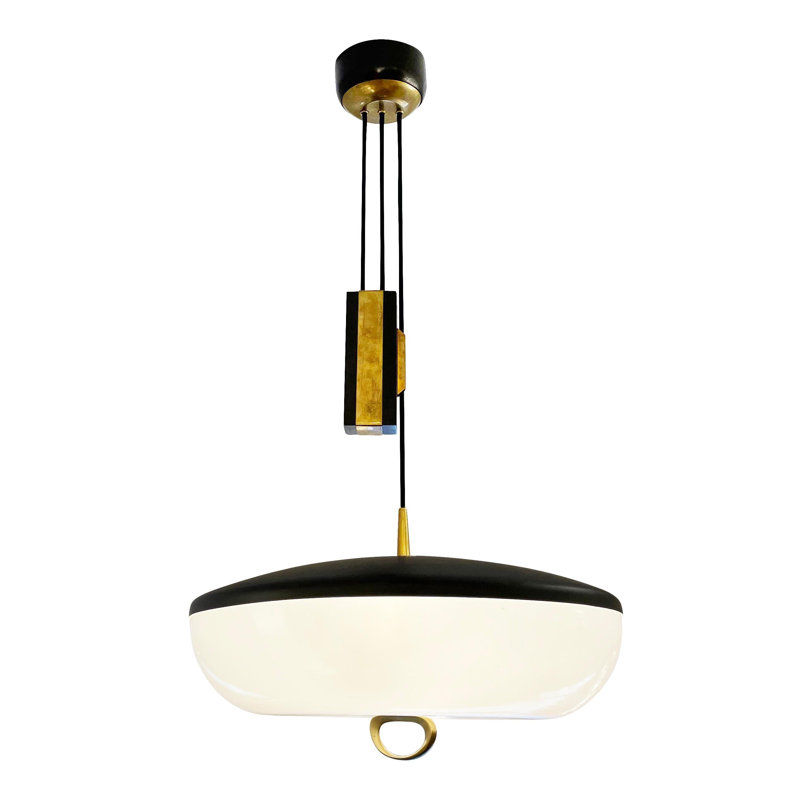 Italian mid-century pendant by Stilnovo with an elegant counter weight mechanism which allows for the drop to be easily adjustable. The shade has a black lacquered hood, perspex shade and brass handle. Holds three candelabra bulbs.

Condition: