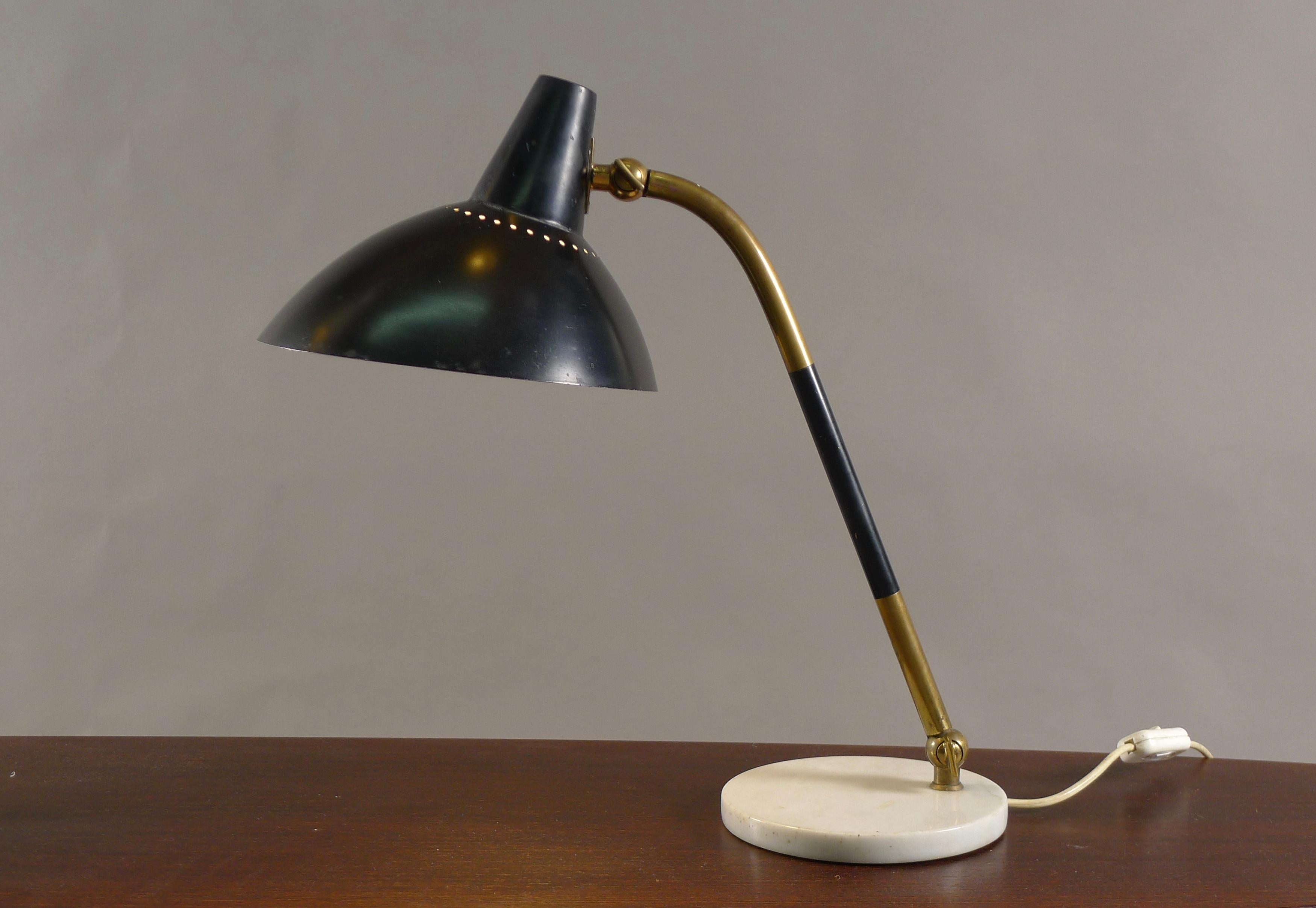 Stilnovo, Italy, Desk lamp, 1950's, model D491 in enamelled black metal shade on articulating brass stem supported by marble base. Label to interior of shade. The shade articulates where it meets the stem and the stem adjusts at the point where it