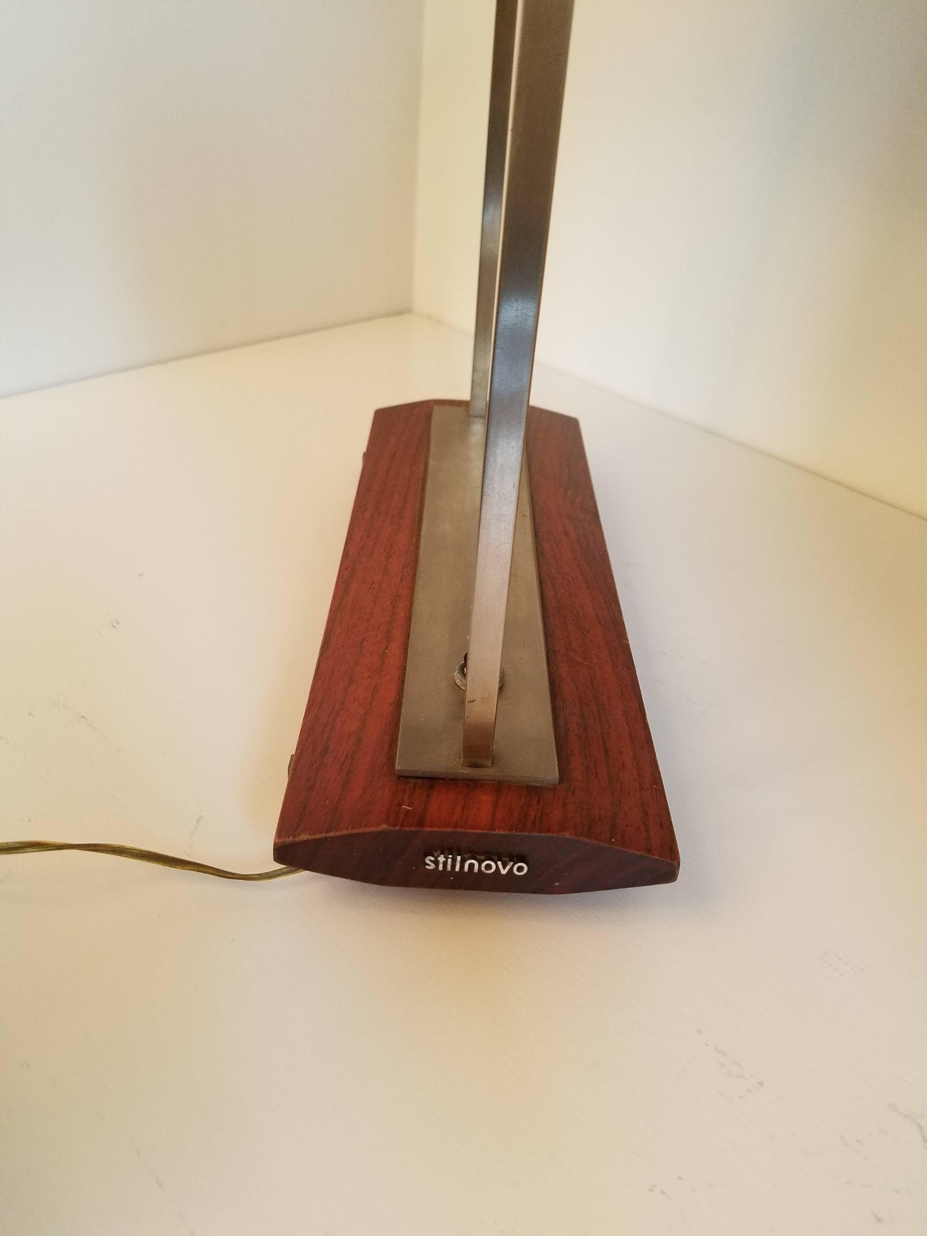 Streamlined vintage desk lamp (stamped Stilnovo) with walnut base and details and stainless steel,
circa 1955.