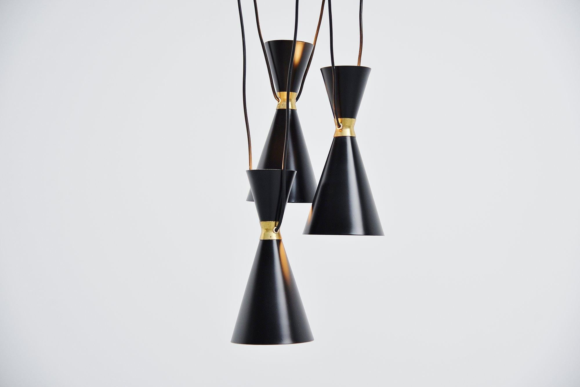 Very nice spectacular 3 shades chandelier by Stilnovo, Italy 1950. This chandelier has 3 diabolo shaped shades. There are 2 sockets per shade so the lamp lits up and down. The round black ceiling plate is not included with this lamp, the canopies