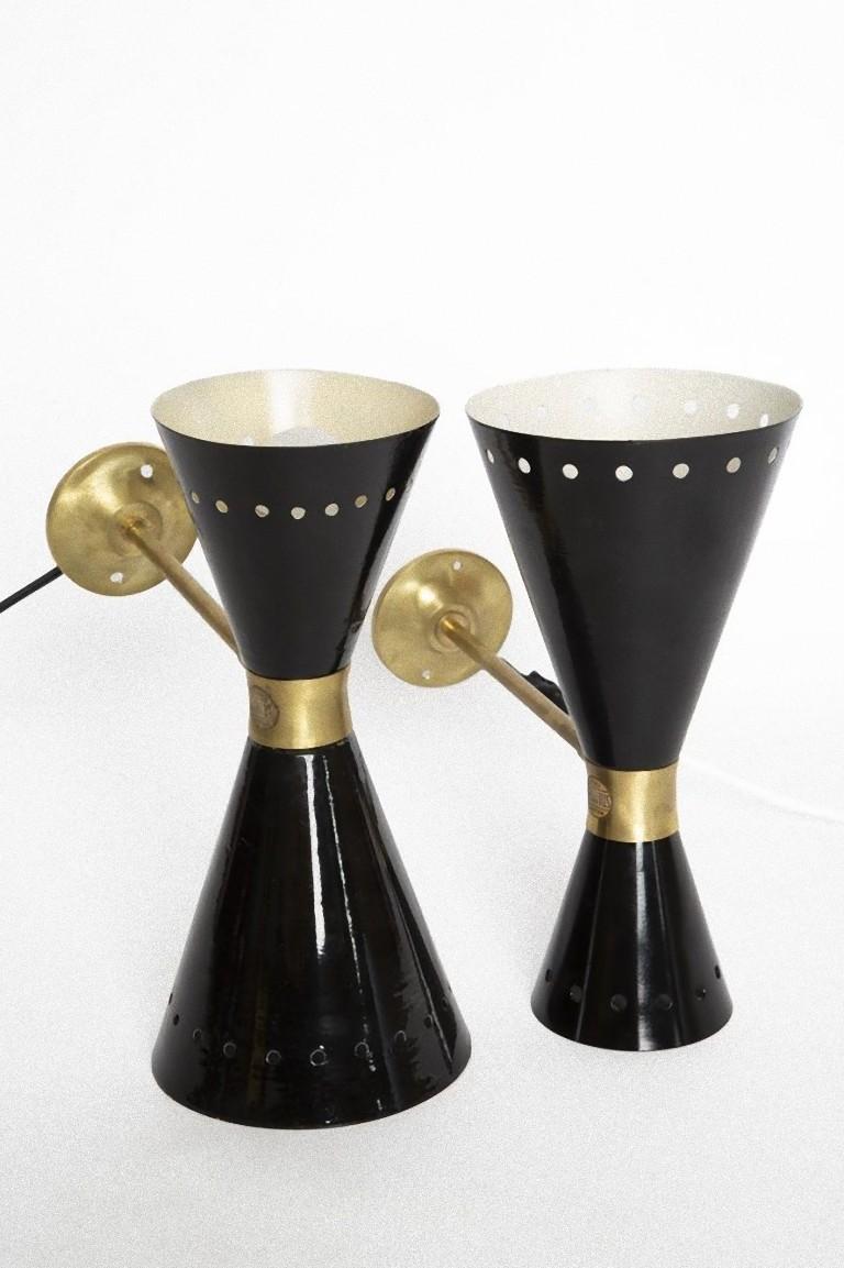 Stilnovo Diabolo wall lamps are two iconic wall lamps realized in Italy, in the 1960s by Stilnovo.

Double wall lamps, black painted with brass details.

Fully adjustable.
 