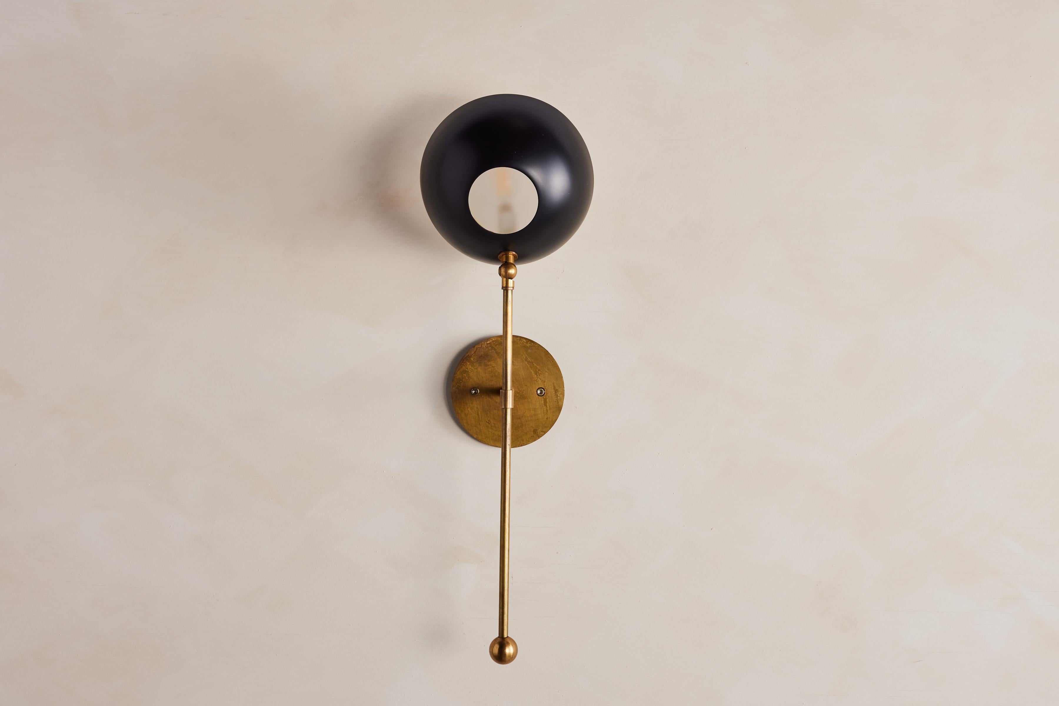 Italian Metal sconces in the style of Stilnovo, newly produced in Italy.

Black Dome metal shade with frosted glass and brass hardware.

Shade articulates / pivots - arm does not. 

Wired to American standards.

Priced individually. 