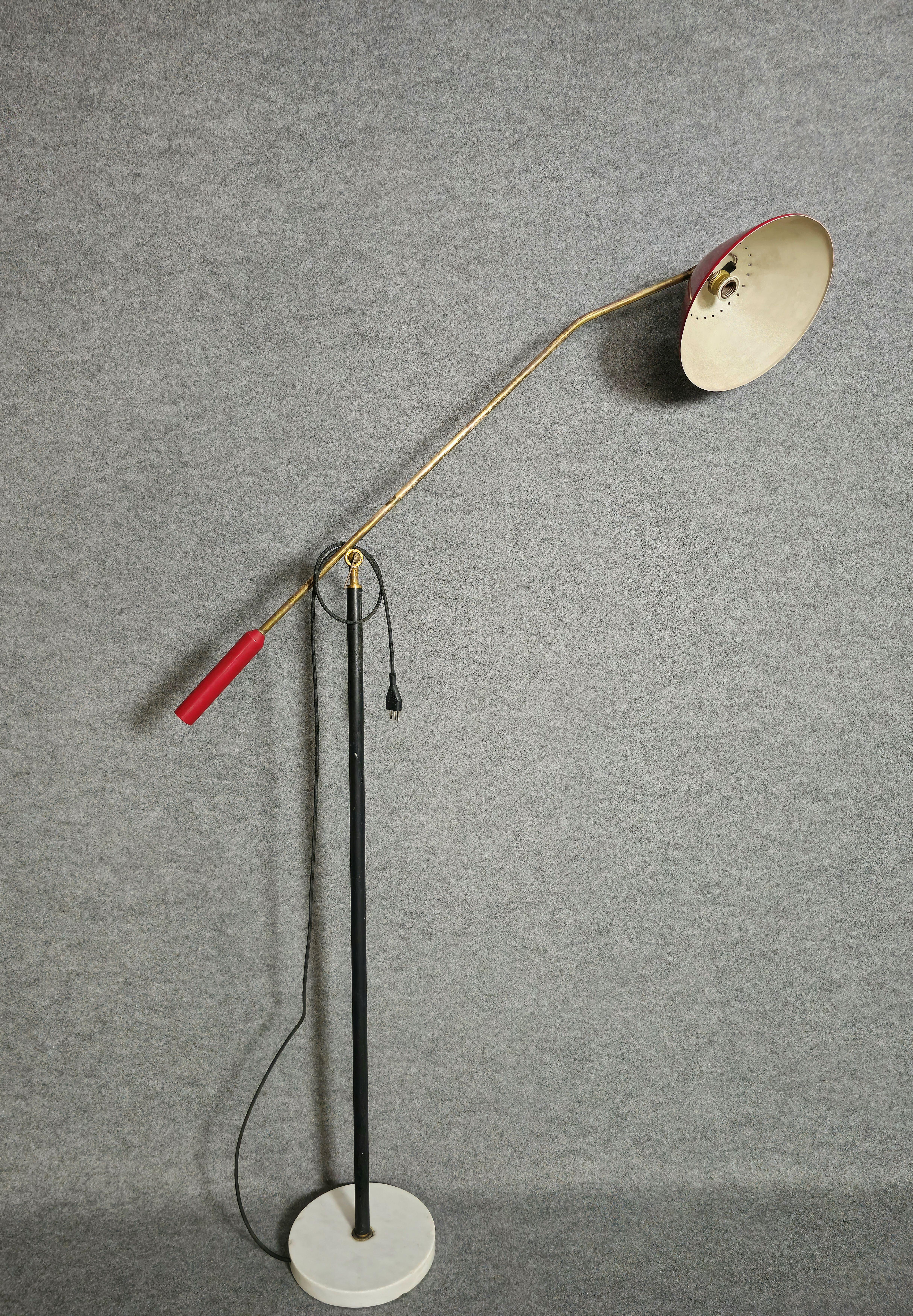 Adjustable floor lamp by Stilnovo, 1950s. Circular marble base. Black enamelled brass stem. A brass joint allows the arm to adjust in height. Brass arm with red counterweight and red enamelled lampshade. Thanks to a joint, the lampshade can also be