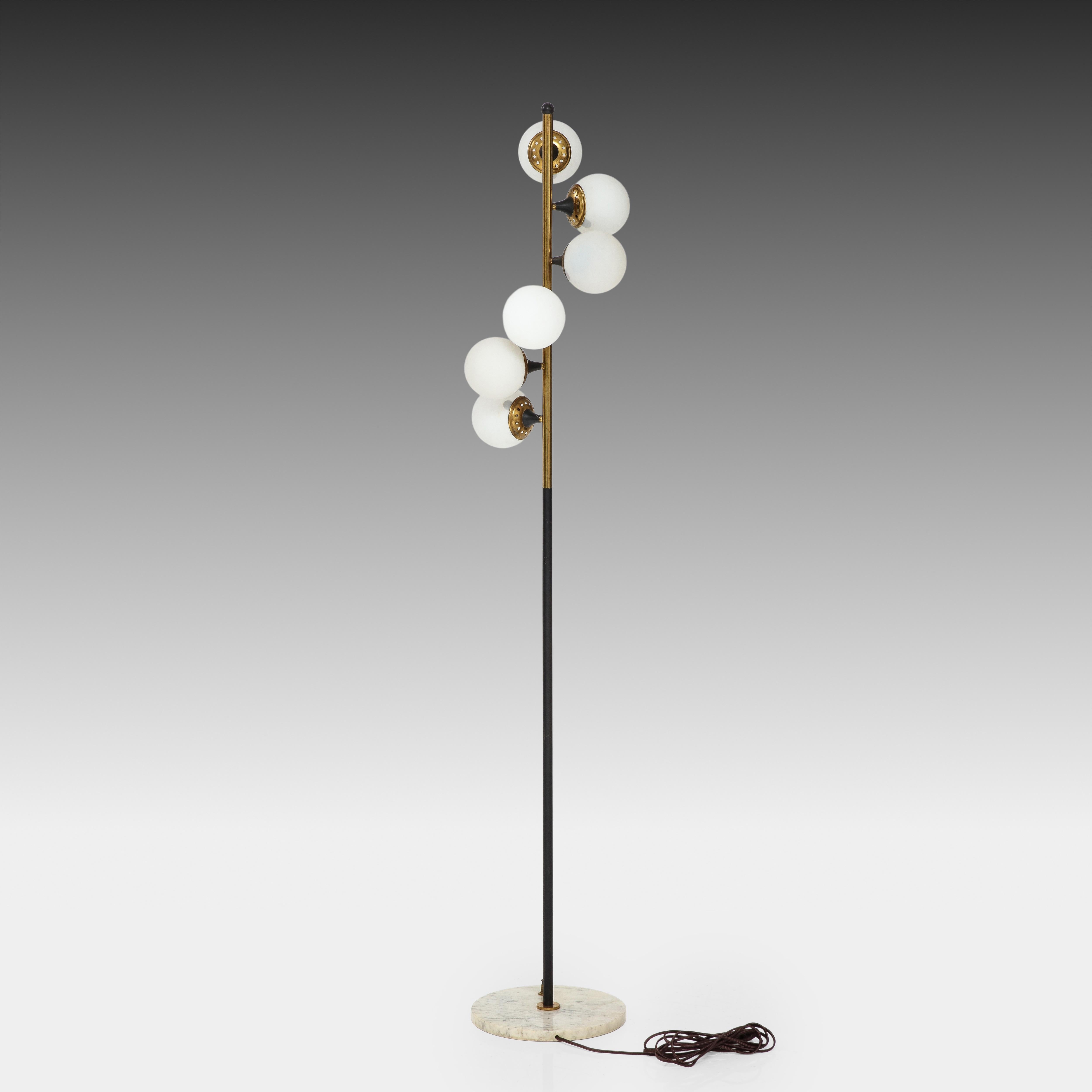 Stilnovo floor lamp composed of six frosted opaline glass balls cascading down gilt lacquered brass and black enameled metal stem on white marble base with original foot switch. Beautiful and iconic 1950s Stilnovo design with contrasting colors of