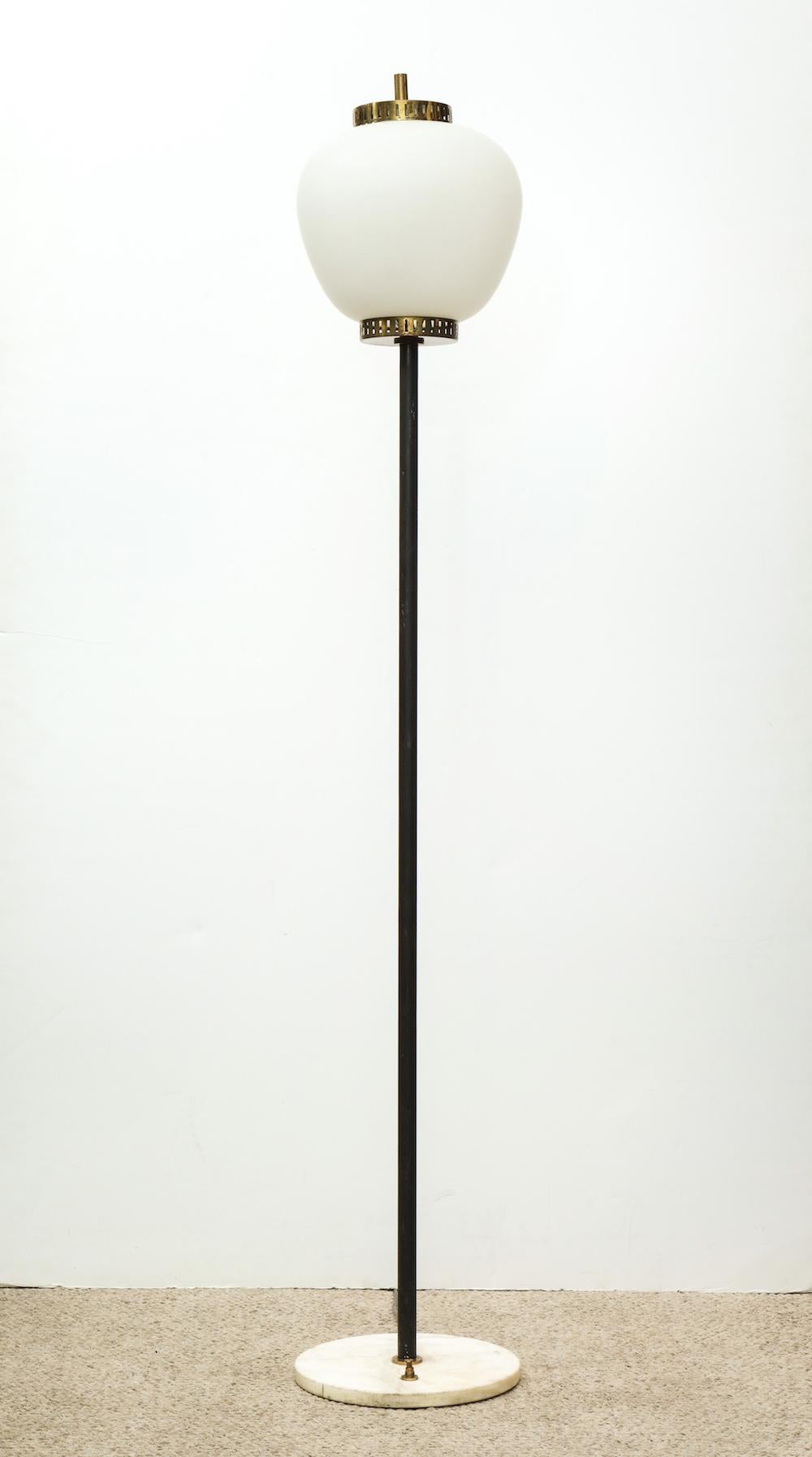 Elegant floor lamp by Stilnovo. Black-painted metal and brass mounts. Frosted glass shade and marble base with original foot-switch. Takes 2 standard-sized edison bulbs. Sockets and wiring has all been recently updated.