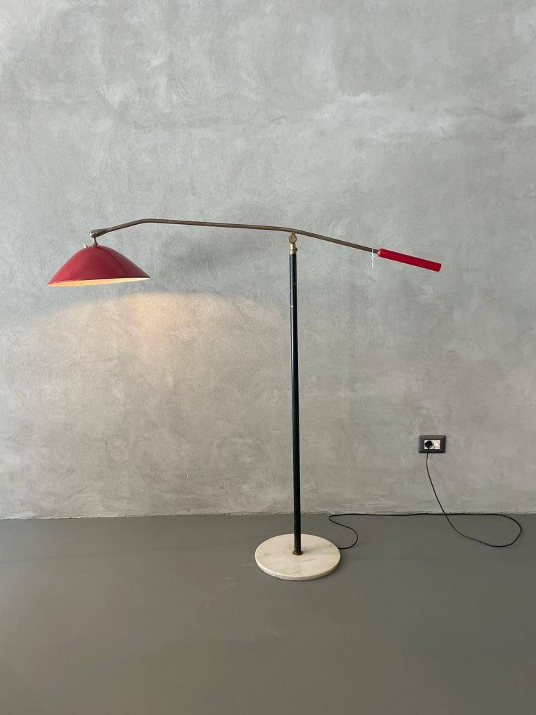 Stilnovo floor lamp manufactured by Stilnovo in Italy, 1950.
Floor lamp has a round Carrara marble base and a black stem that is extendable in height.
Lamp has solid adjustable brass arm and red lacquered aluminum lampshade, which on the top has