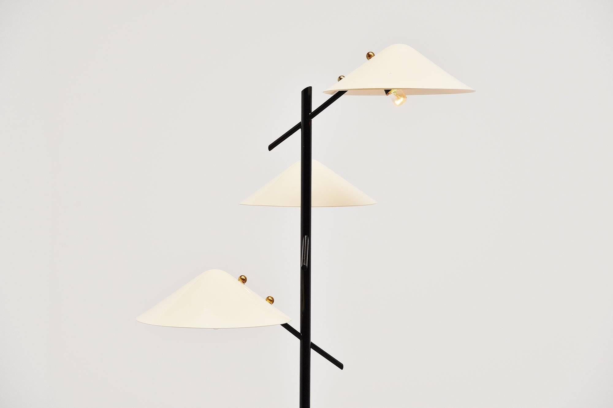 Very nice triple shaded floor lamp designed and made by Stilnovo, Italy, 1950. This lamp has a marble base and black lacquered foot/arms. The shades are made of beige lacquered plexiglass and the lamp has nice brass details. The lamp is very