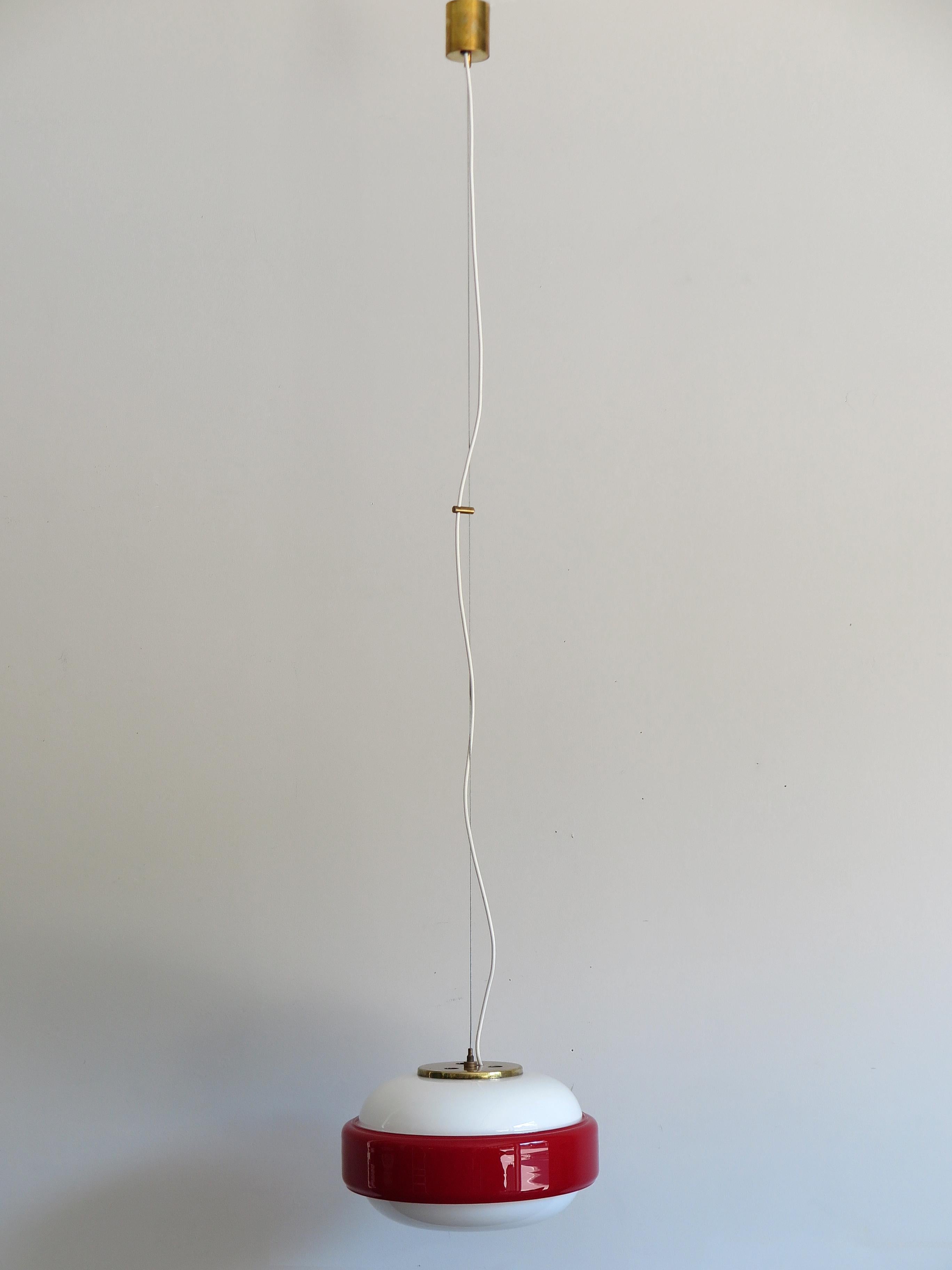 Italian amazing pendant lamp or hanging light produced by Stilnovo from 1960; brass, white opaline glasses and incamiciato red glass; original Stilnovo label, circa 1960s.

Please note that the lamp is original of the period and this shows normal