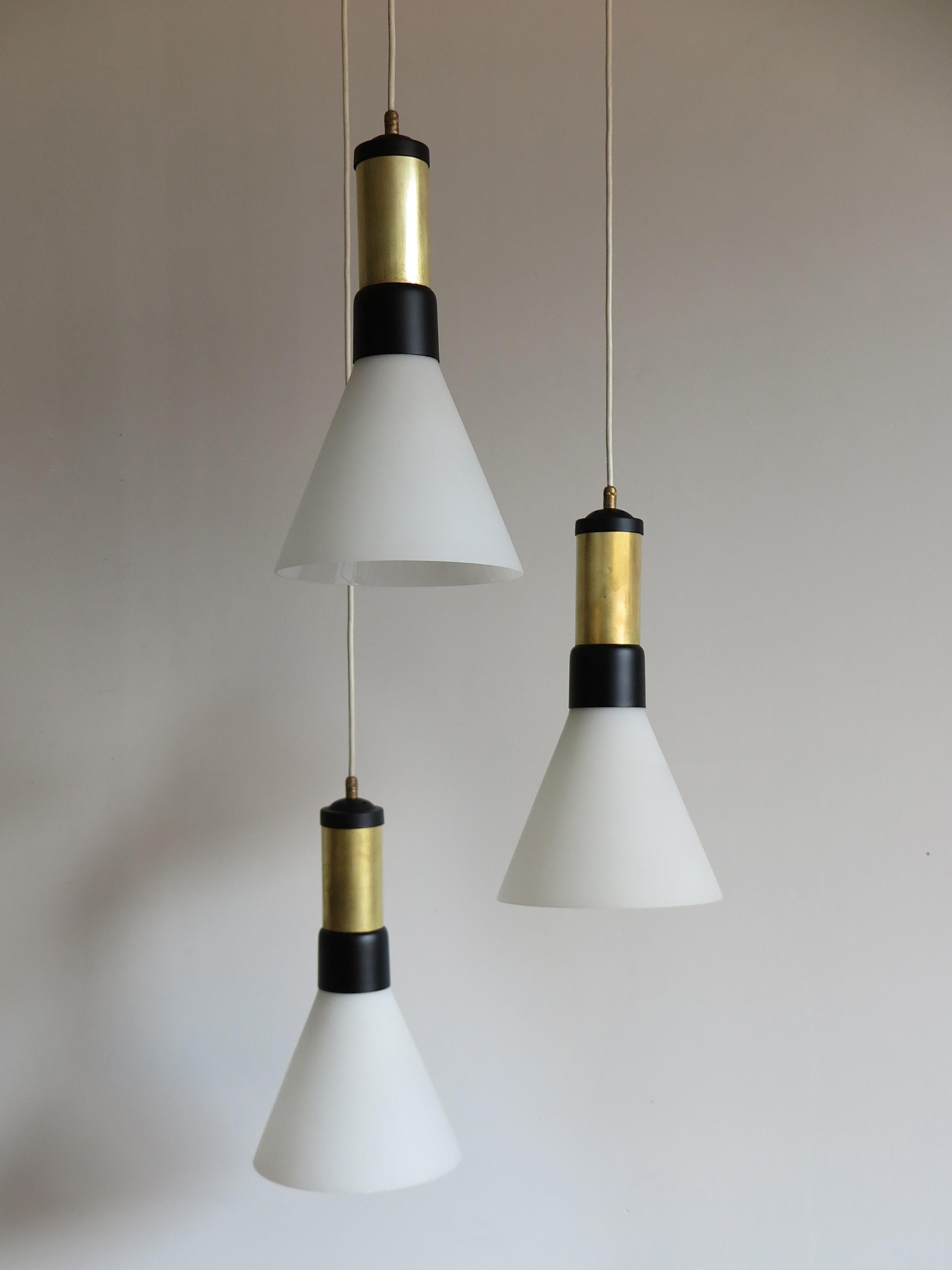 Italian Mid-Century Modern design pendant lamp produced by Stilnovo Milano with opal glass, brass and enameled metal, circa 1950s.

Please note that the lamp is original of the period and thus shows normal signs of age and use.