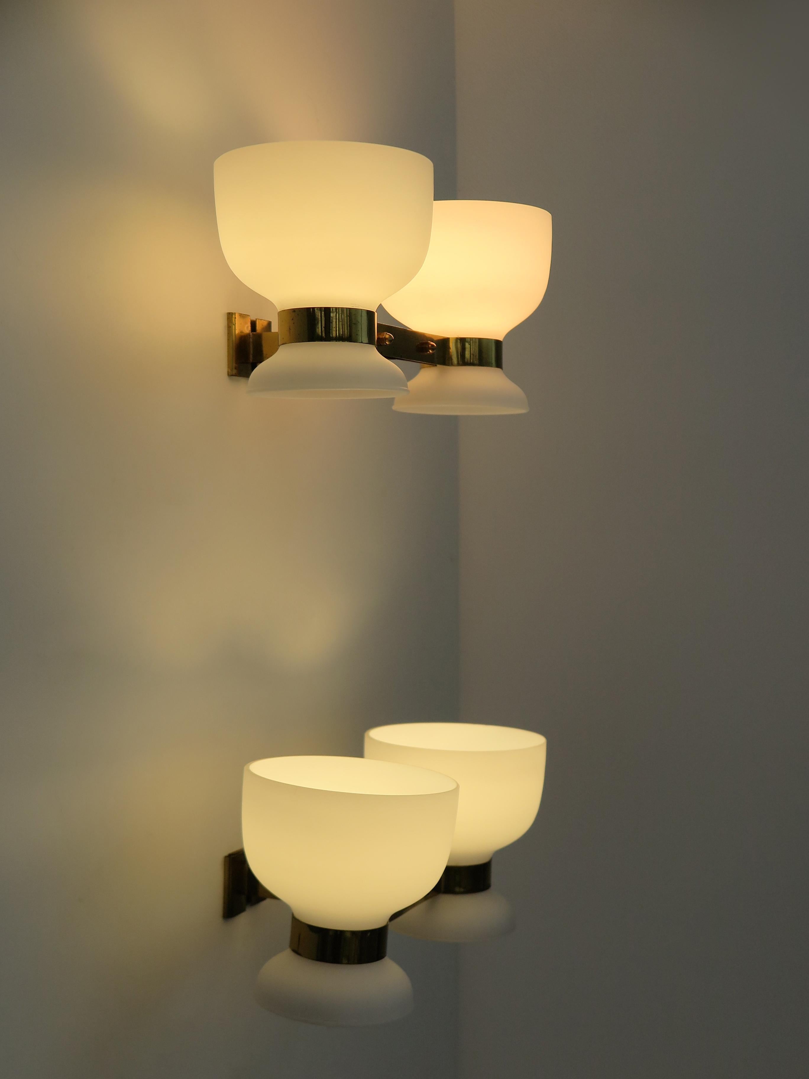 Pair of wall lamps wall sconces produced by Stilnovo with opaque white glass diffusers and brass srtructure, 1950s Italy production

Note that the lamp is original to the period and shows the normal signs of age and use.