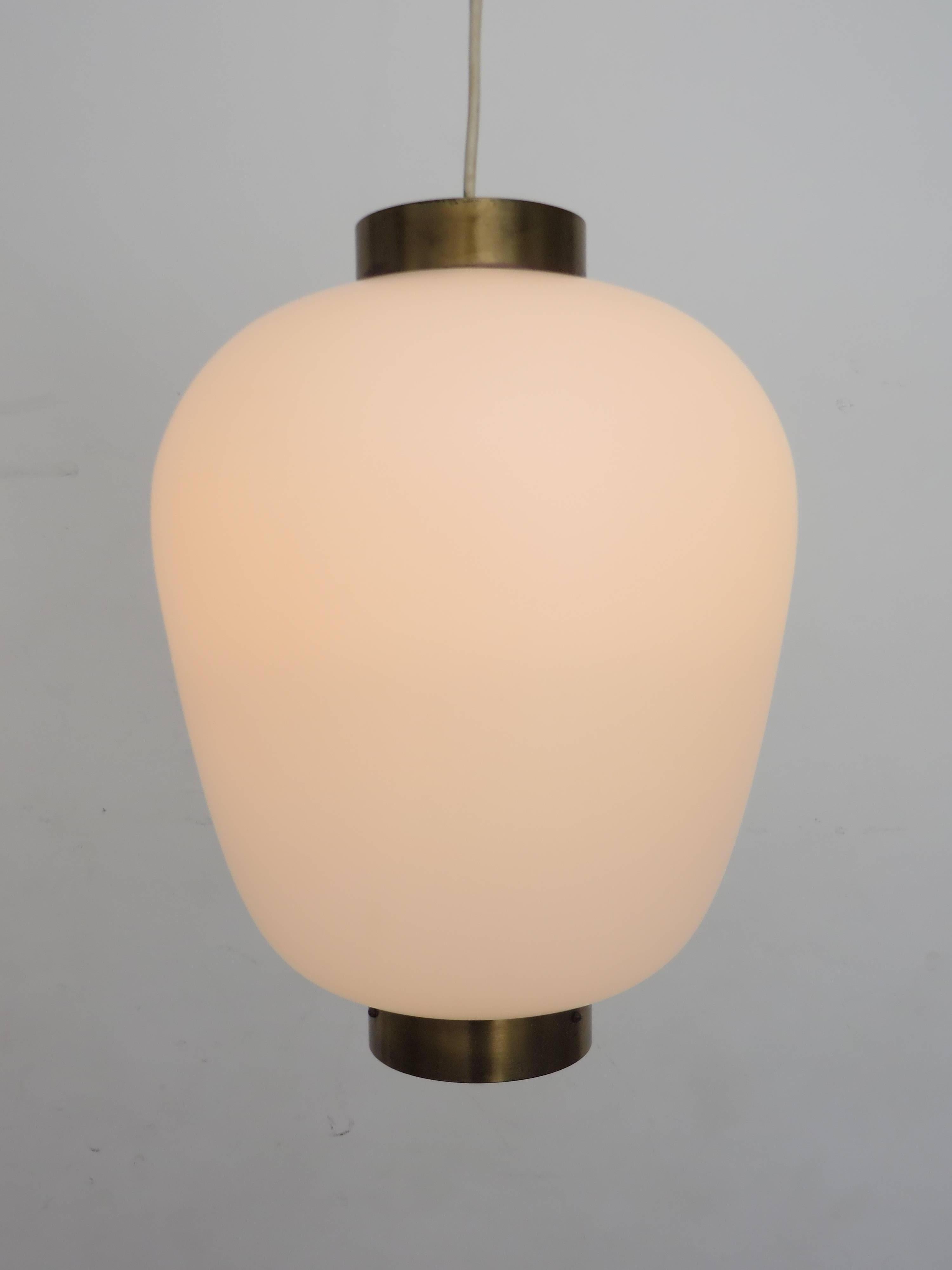 A pendant light by Stilnovo designed and manufactured in Italy, circa 1960s.
Brushed satin opaque glass diffuser and brass details top and bottom. Original ceiling cap.
A very Asian Minimalist reference.
Rewired for US junction boxes. Takes one