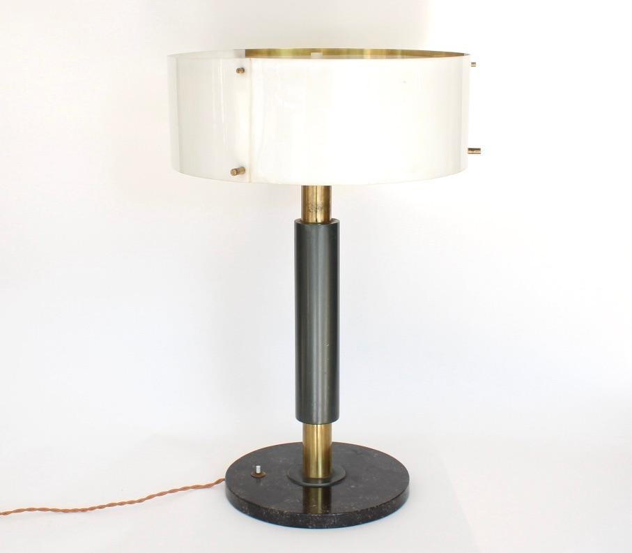 Stilnovo attributed table lamp. Tubular brass column with lacquered gray brass center supporting a circular perspex and brass shade, with iconic Stilnovo brass pegs on the shade and perspex diffuser. Three original sockets. No label intact.