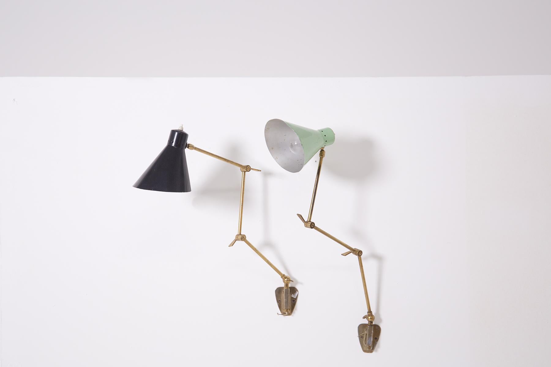 Pair of Stilnovo manufactured wall lamps of the 1950s. The wall lamps are adjustable. The adjustable brass structure allows to shape the lamp in various positions. The lamp holder cap is made of painted aluminium. One lamp is black and the second