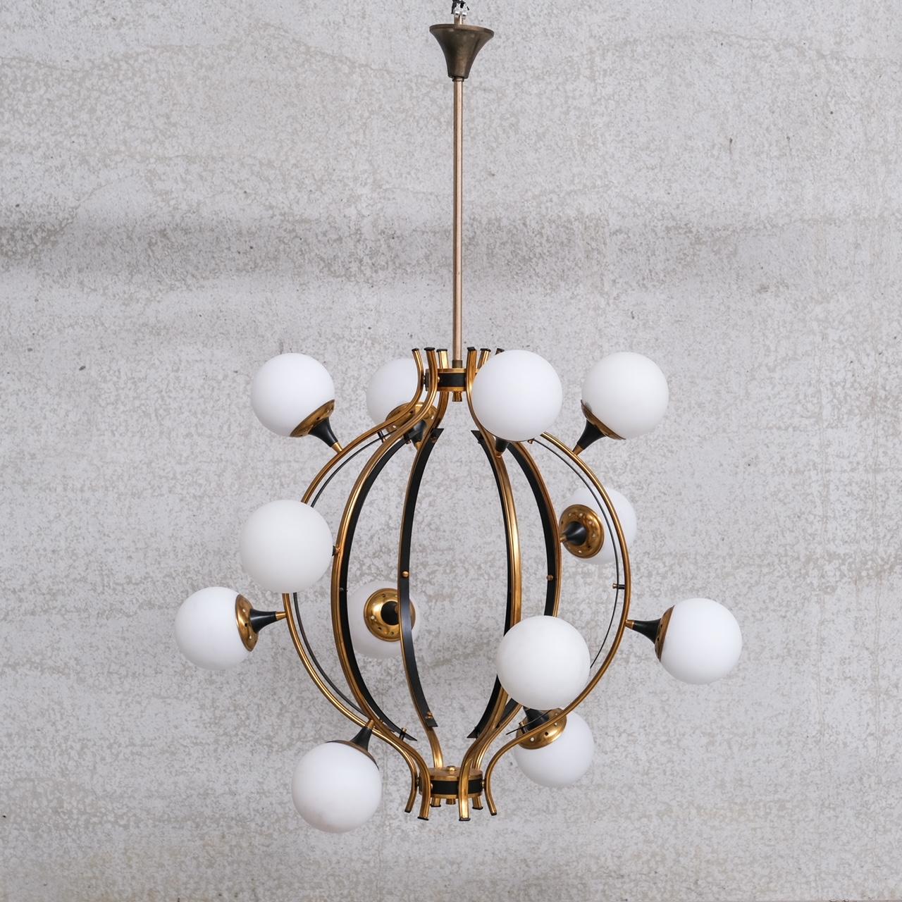 A large chandelier attributed to Stilnovo.

Italy, c1950s.

Brass, lacquered metal and opaline glass spheres.

Since re-wired and PAT tested.

Good vintage condition, some scuffs and wear commensurate with age.

Internal ref: