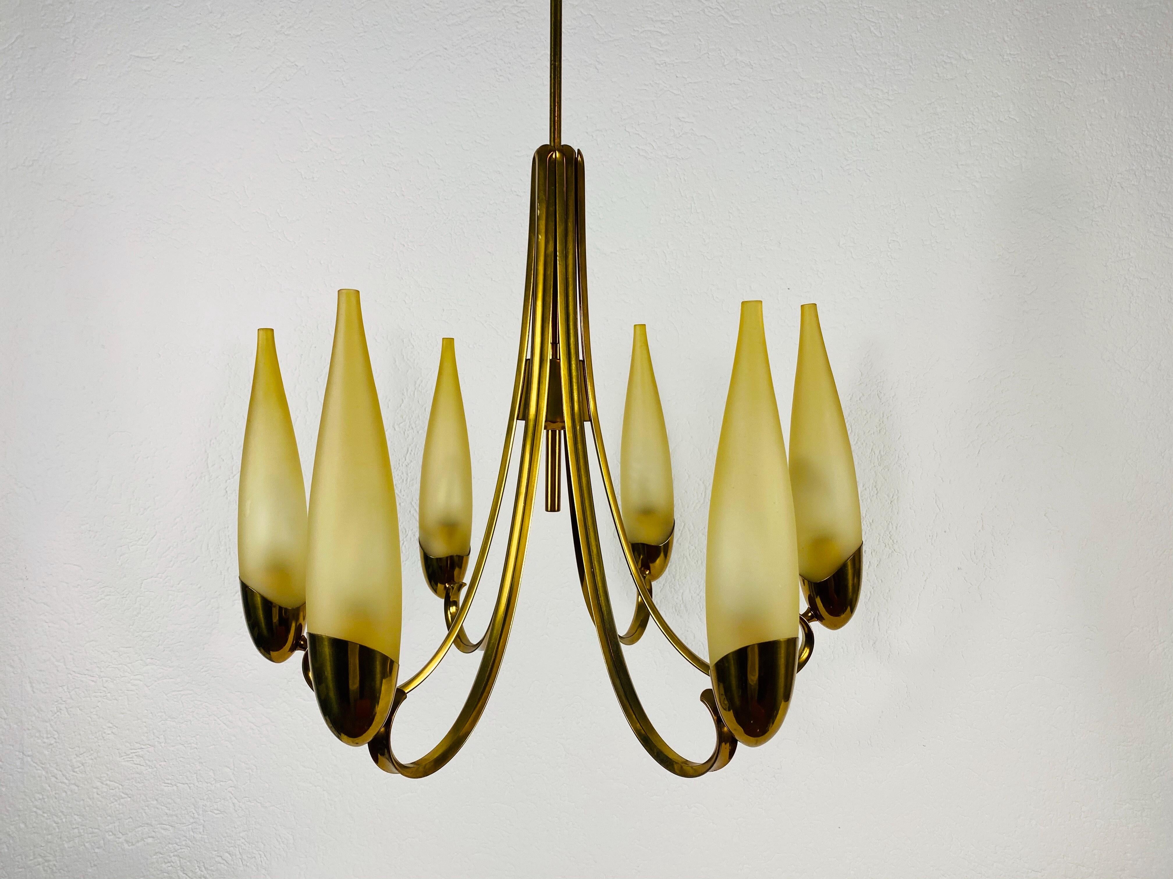 An Italian midcentury chandelier made in the 1960s, attributed to Stilnovo. It is fascinating with its monumental design and 8 glass elements. The body of the light is made of polished brass, including the arms.

Very good vintage condition. The