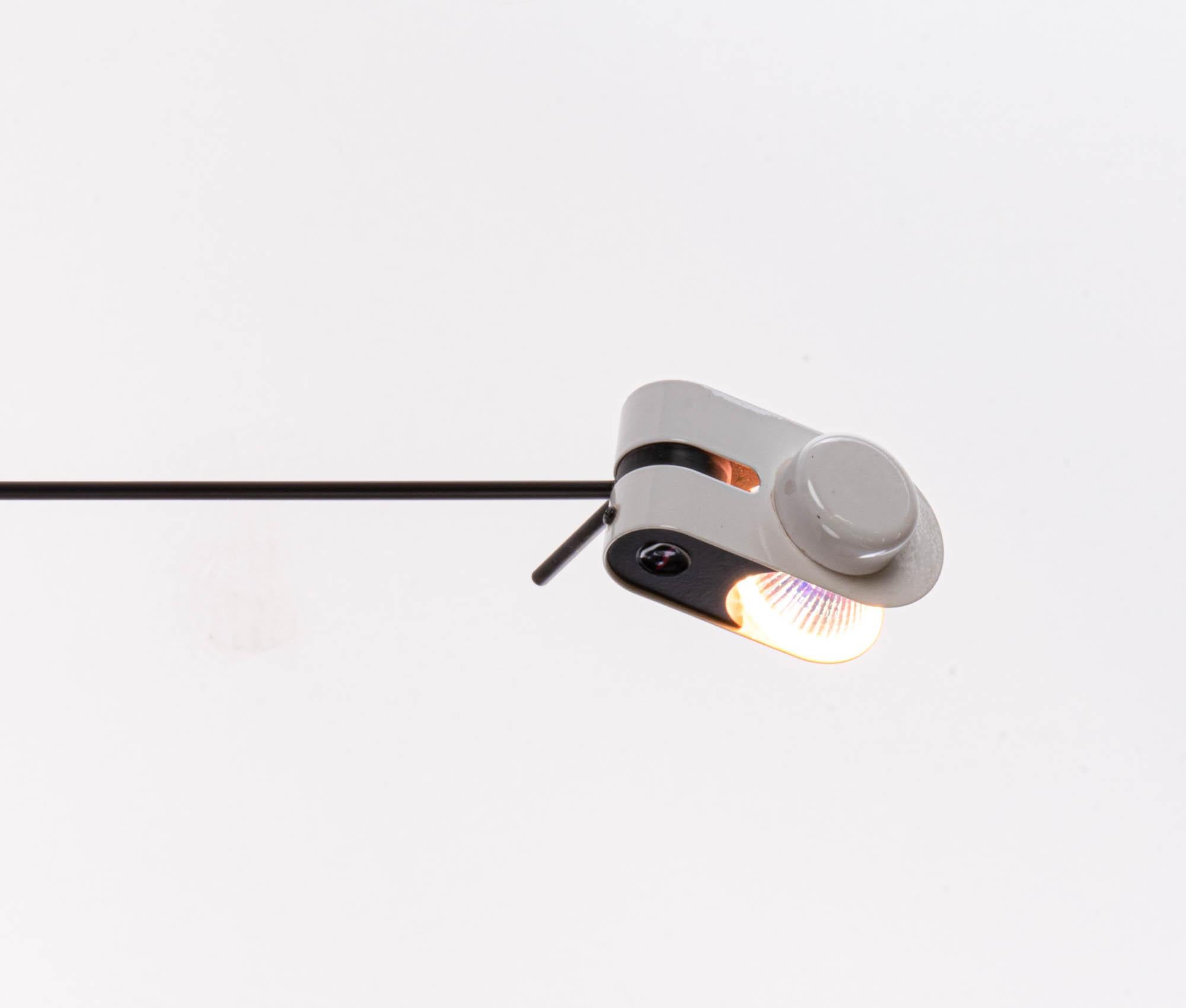 Minimalist halogen wall and ceiling lamp with a black and white metal frame. The head on the telescopic arm is movable. Thus, the light can be aligned selectively. Manufactured by Stilnovo, Milano, Italy in the 1980s. 

Design: Stilnovo. 
Measures: