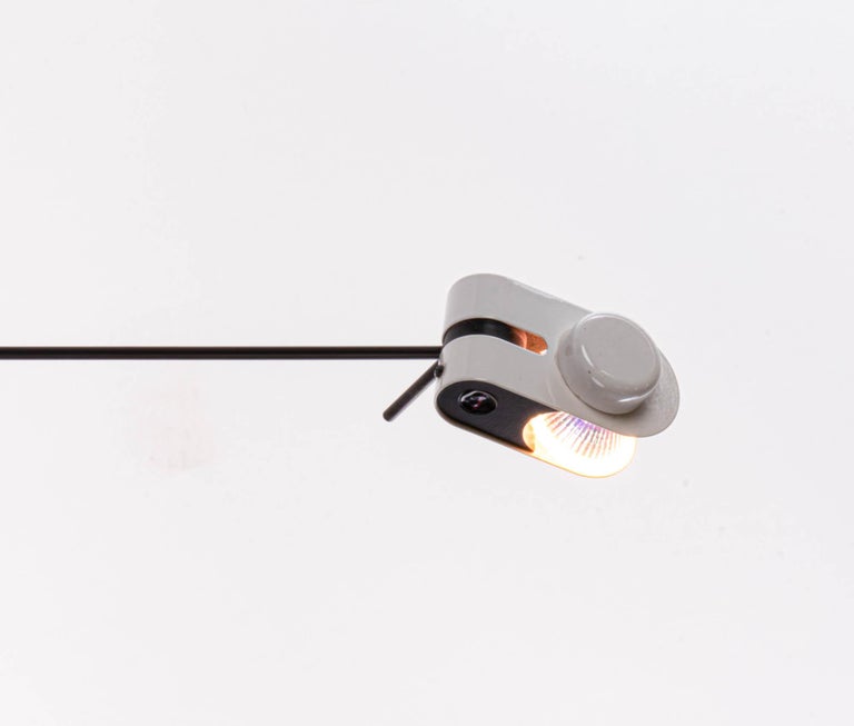 Minimalist halogen wall and ceiling lamp with a black and white metal frame. The head on the telescopic arm is movable. Thus, the light can be aligned selectively. Manufactured by Stilnovo, Milano, Italy in the 1980s. 

Design: Stilnovo. 
Measures: