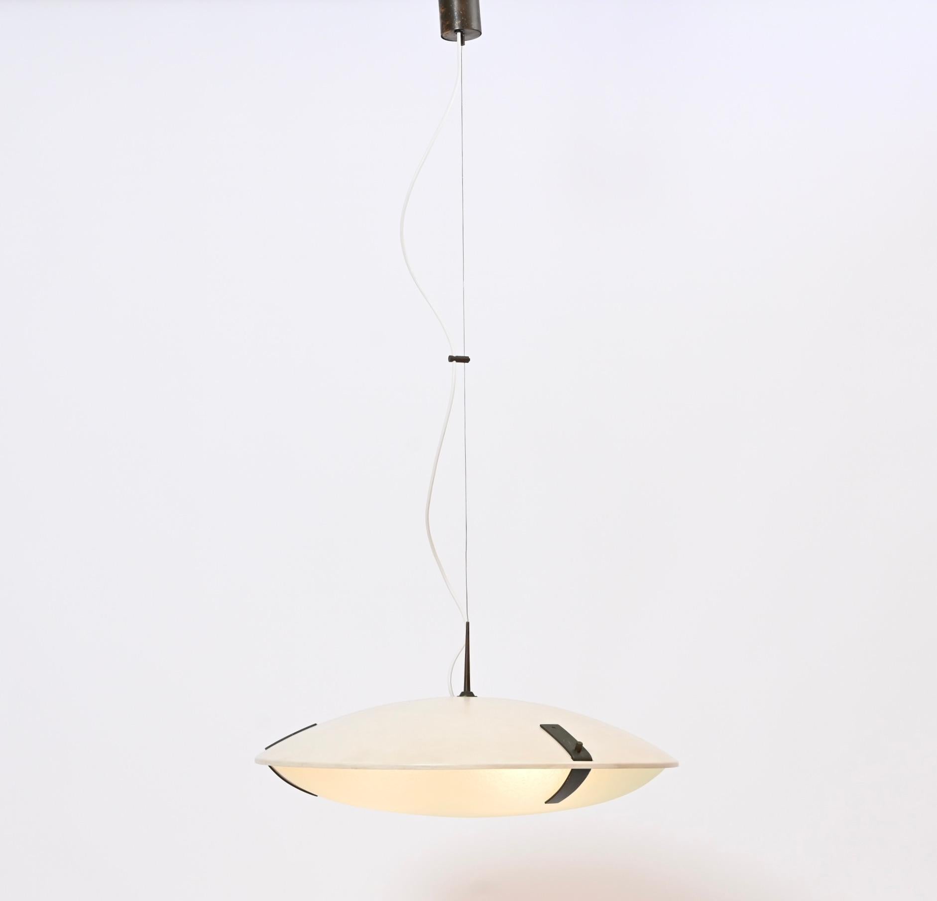 This 1960s Italian ceiling light, model ‘1140’, was designed and produced by Bruno Gatta’s Milanese company, Stilnovo, The height adjustable wire-suspended pendant comprises of a cream painted-steel dome and a decorative acid-etched glass diffuser