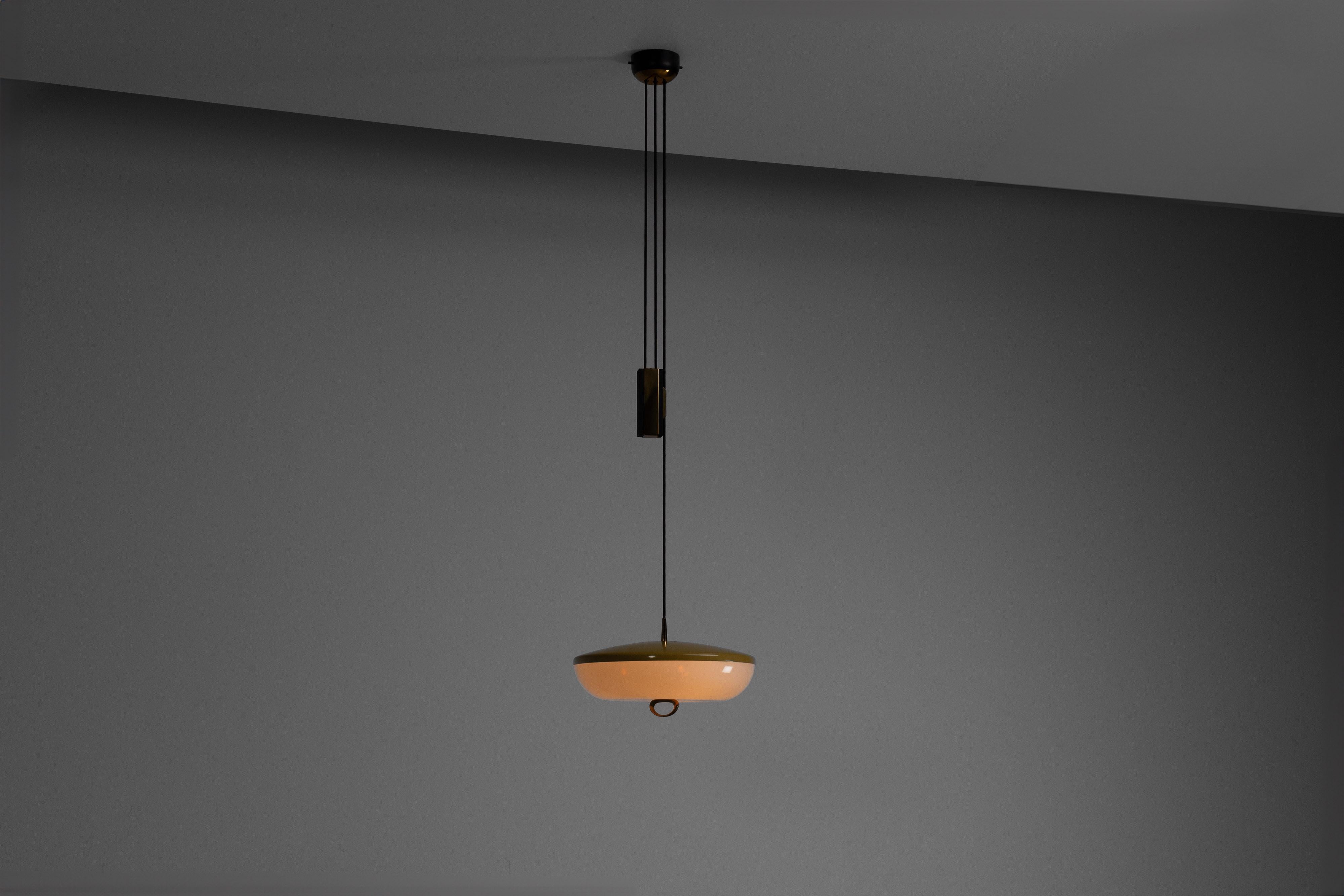 The rare model 1177 pulley pendant, designed and manufactured by Stilnovo in Italy circa 1960, is a striking example of mid-century lighting design. Known for their innovative approach and high-quality craftsmanship, Stilnovo created this pendant