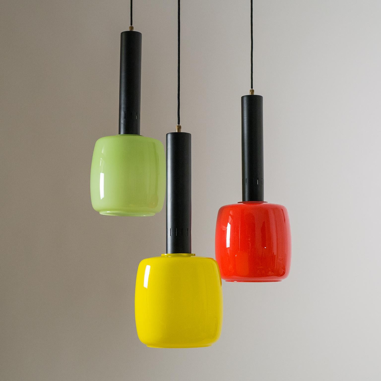 Bold multi-color glass chandelier by Stilnovo, circa 1960. Three large (8.5inch/22cm diameter) blown and cased glass bodies are suspended by brass and lacquered aluminum hardware. One E27 socket per glass.
 
