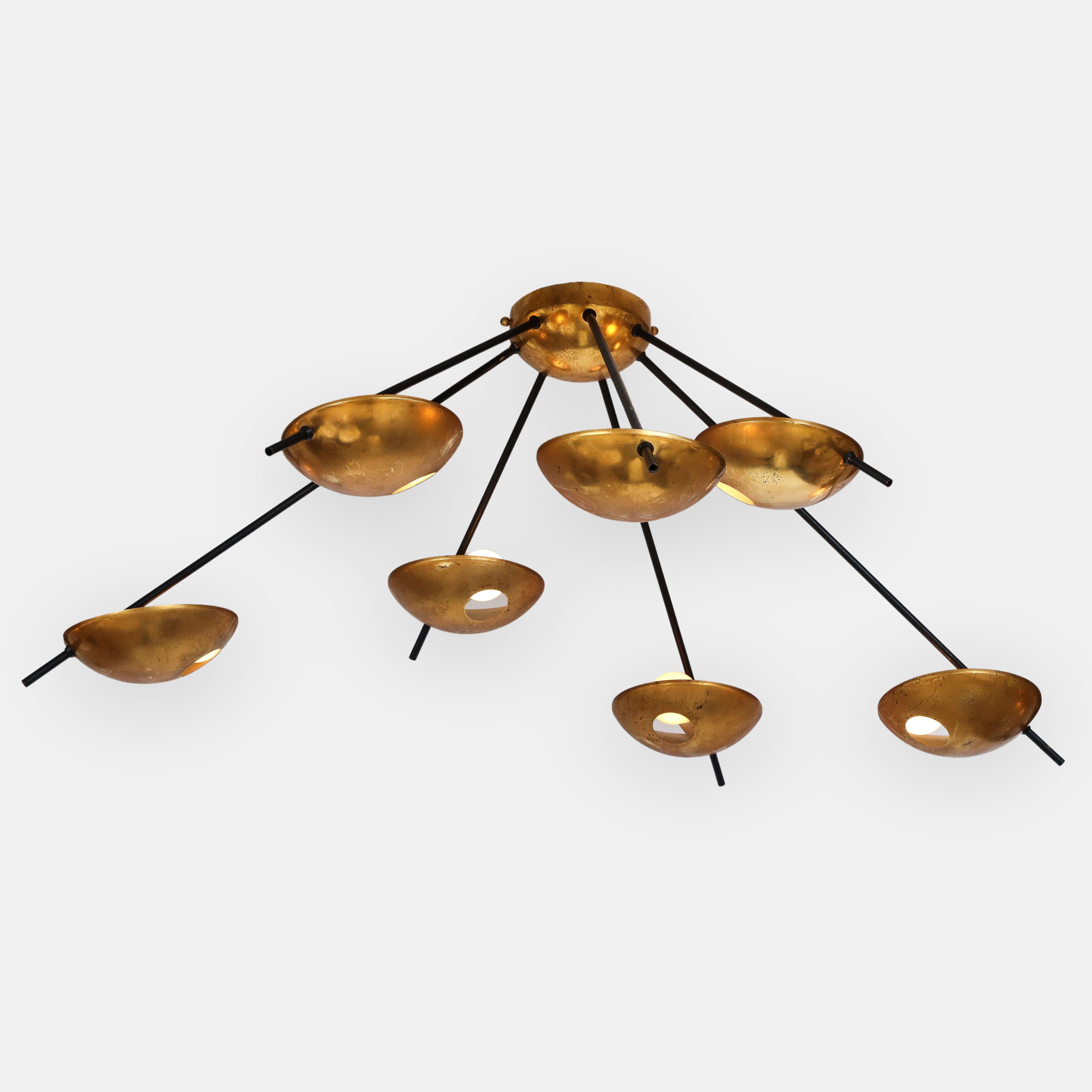 Stilnovo original architectural ceiling or wall light model 1036 composed of seven lights with brass shades on black enameled metal arms of different lengths radiating from central canopy or mount, Italy, 1950s. This chic iconic and mid-century