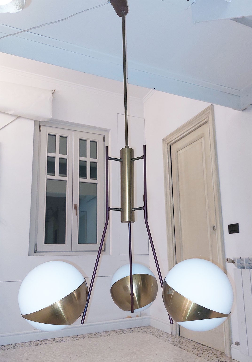 Beuatiful Chandelier by Stilnovo with three brass reflectors with inside glass spheres.
The central brass body support three brown/ burgundy lacquered arms, in the typical Stilnovo colour. 

Measure: diameter of the glasses : 17 cm / 6.69 inches