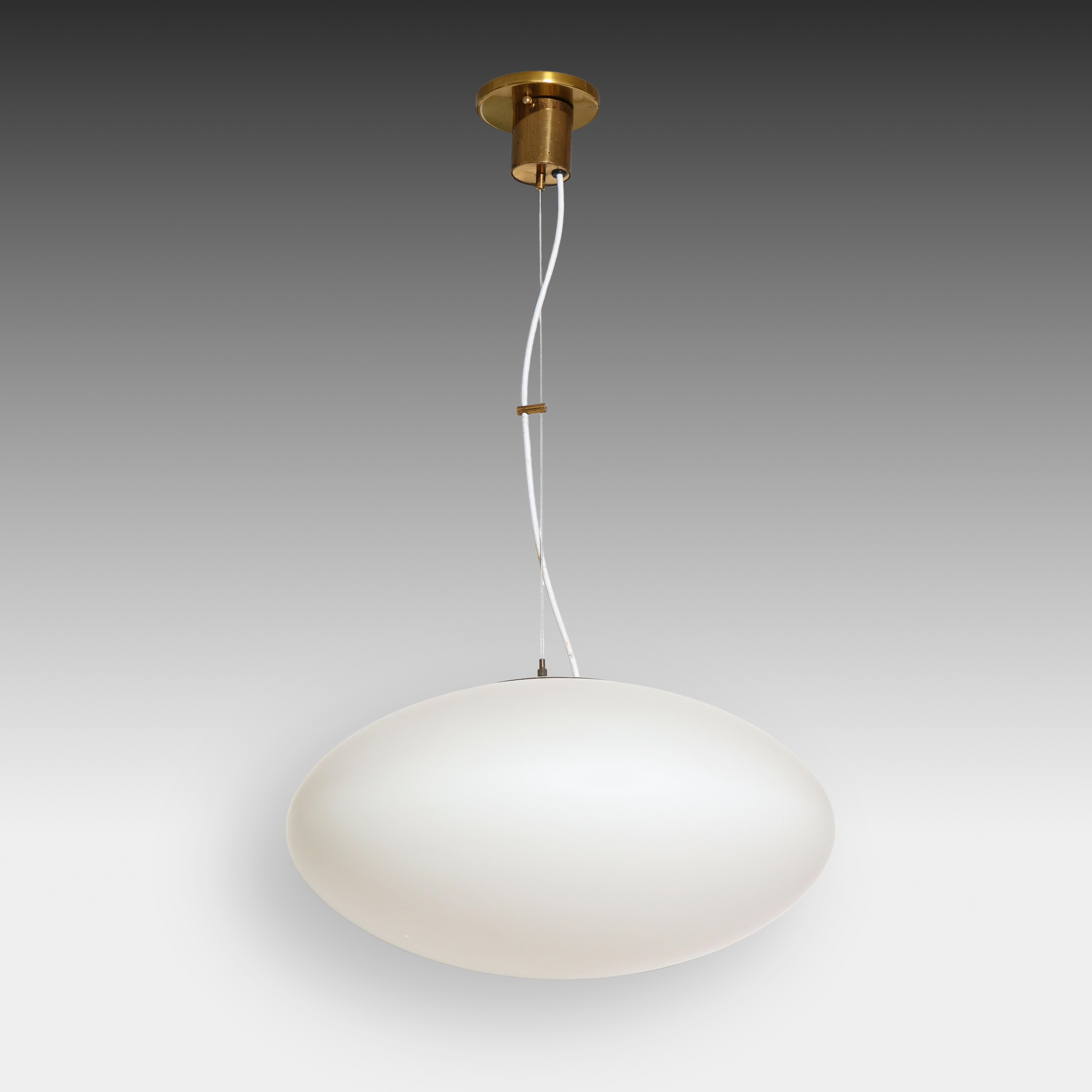 Stilnovo original pair of pendant or suspension lights model 1104 with opaque satin glass diffuser, enameled metal, original brass canopy with matching custom ceiling plate. The opaque glass diffuser is suspended by a wire so the overall height is