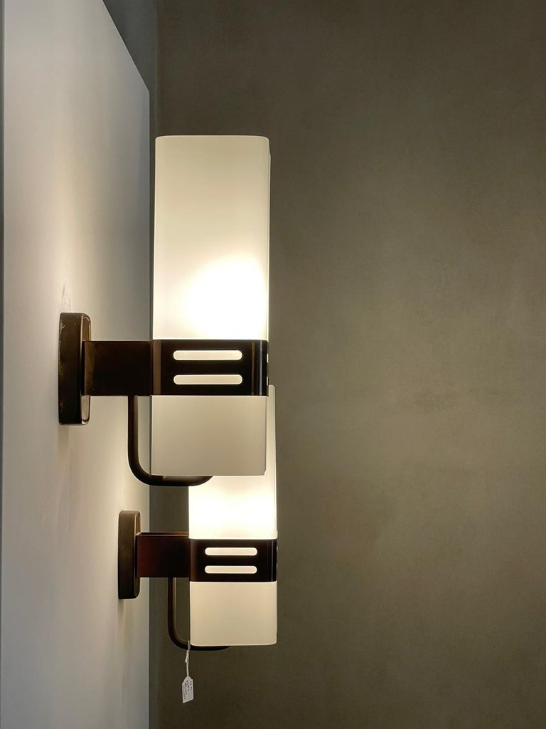 Pair of wall lights manufactured by Stilnovo Italy, 1960s.
Brass structure, opal glass diffusers.
Brass band has vertical perforation detail.
