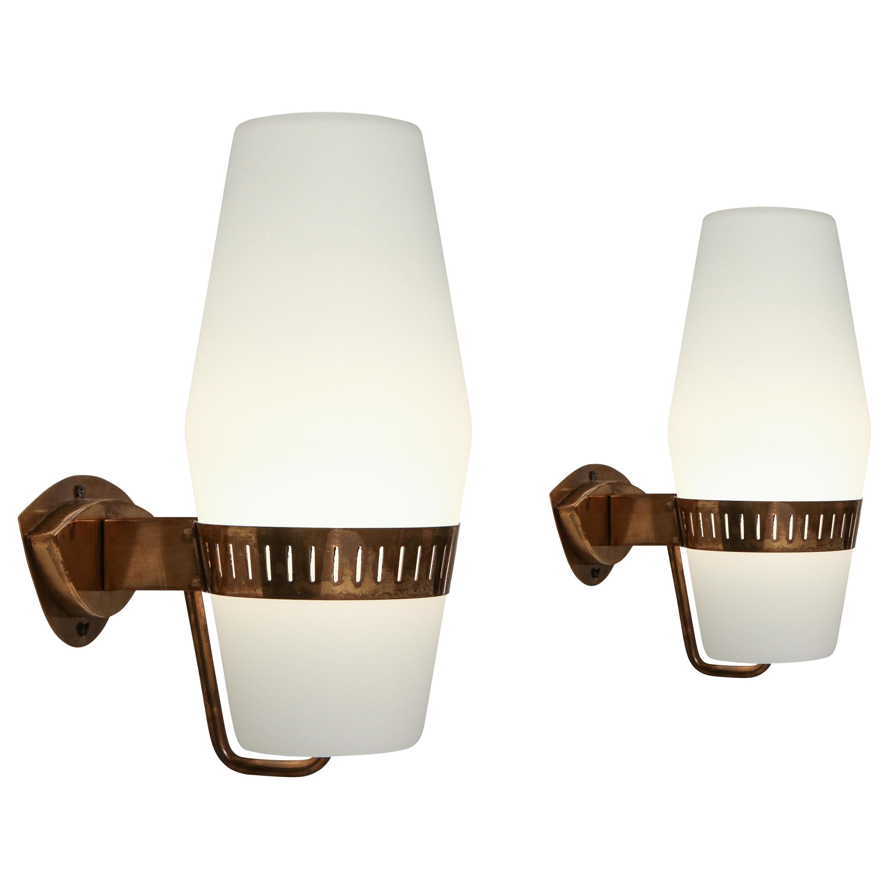 Stilnovo set of four or pairs of elegant sconces model 2078 with large frosted glass lantern-shaped shades held by brass brackets. Recently rewired to U.S. standards with custom shaped backplates to fit original backplates in keeping with its