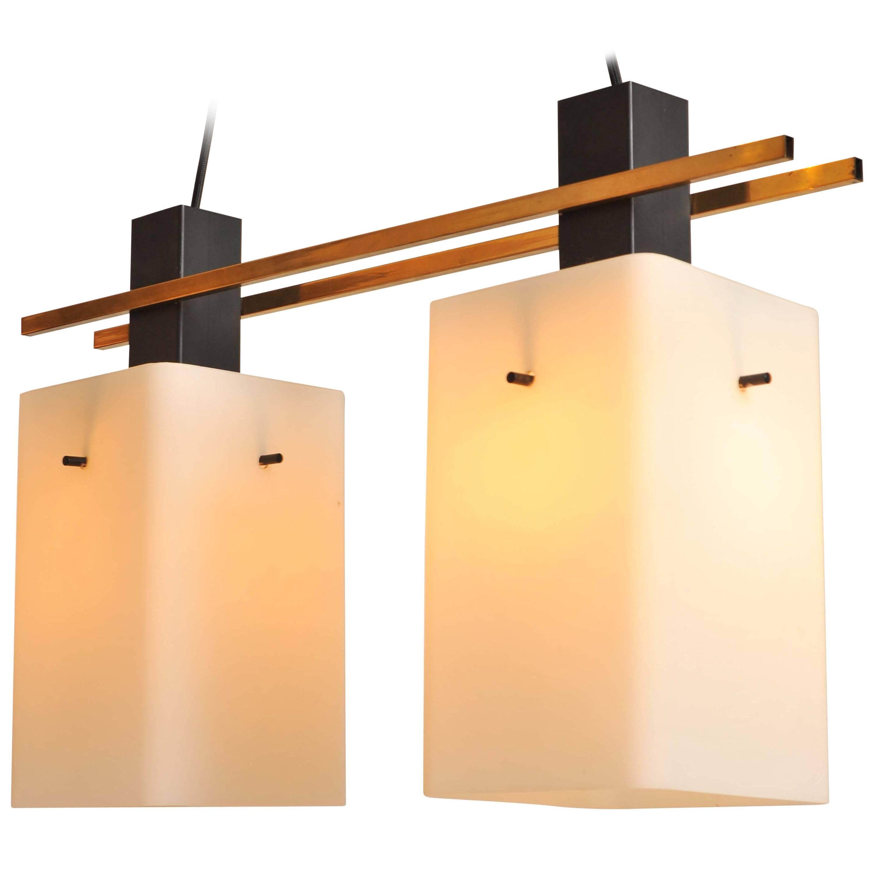 A pair of Geometric Stilnovo pendant, Italy, circa 1950
Each having two quadrangular opaline glass shades, lacquered metal and brass.

Height adjustable.
Re-wired for Europe and USA.