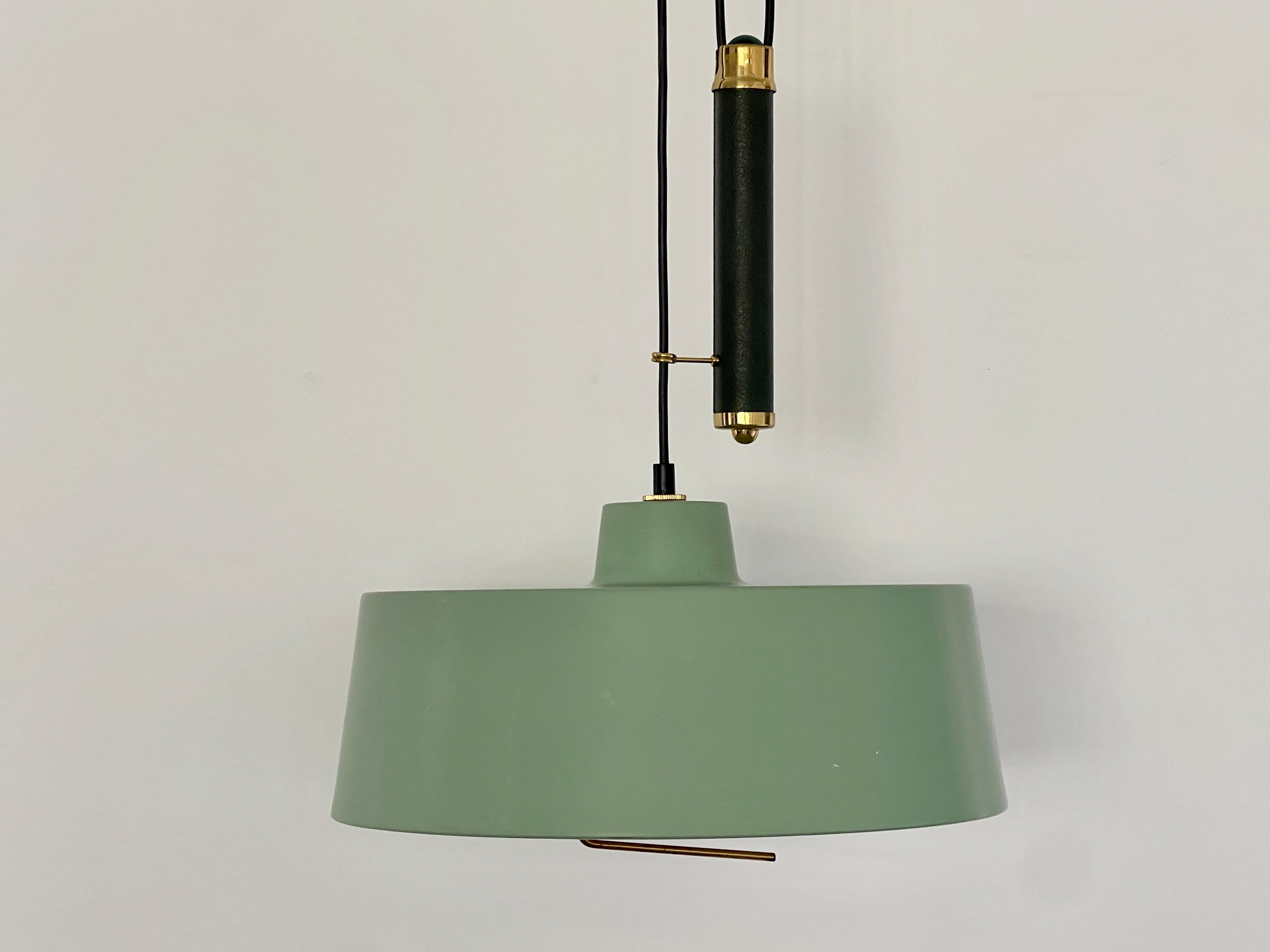 Stilnovo counterbalance pendant with original enameled green shade and canopy.
Skas leather handle with thick brass pulley hardware. 
Measures: Maximum height 86.61 x 14.96 x 14.96 in.