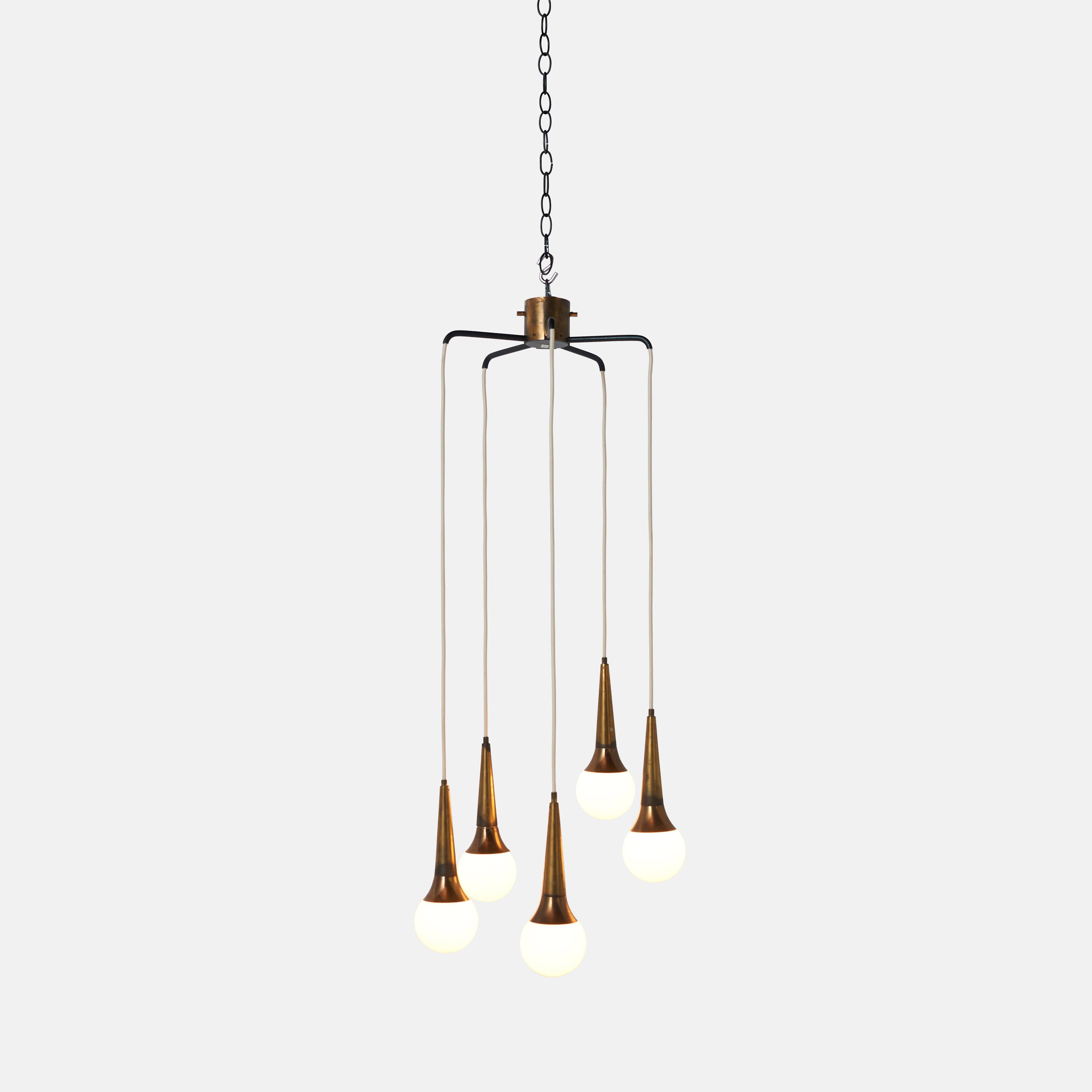 A cascading chandelier produced by Stilnovo in the late 1950s or early 1960's. Featuring five teardrop balls of frosted Murano glass dripping from a brass frame in a multi-level display. Creates a warm aura with interesting shadows when lit.