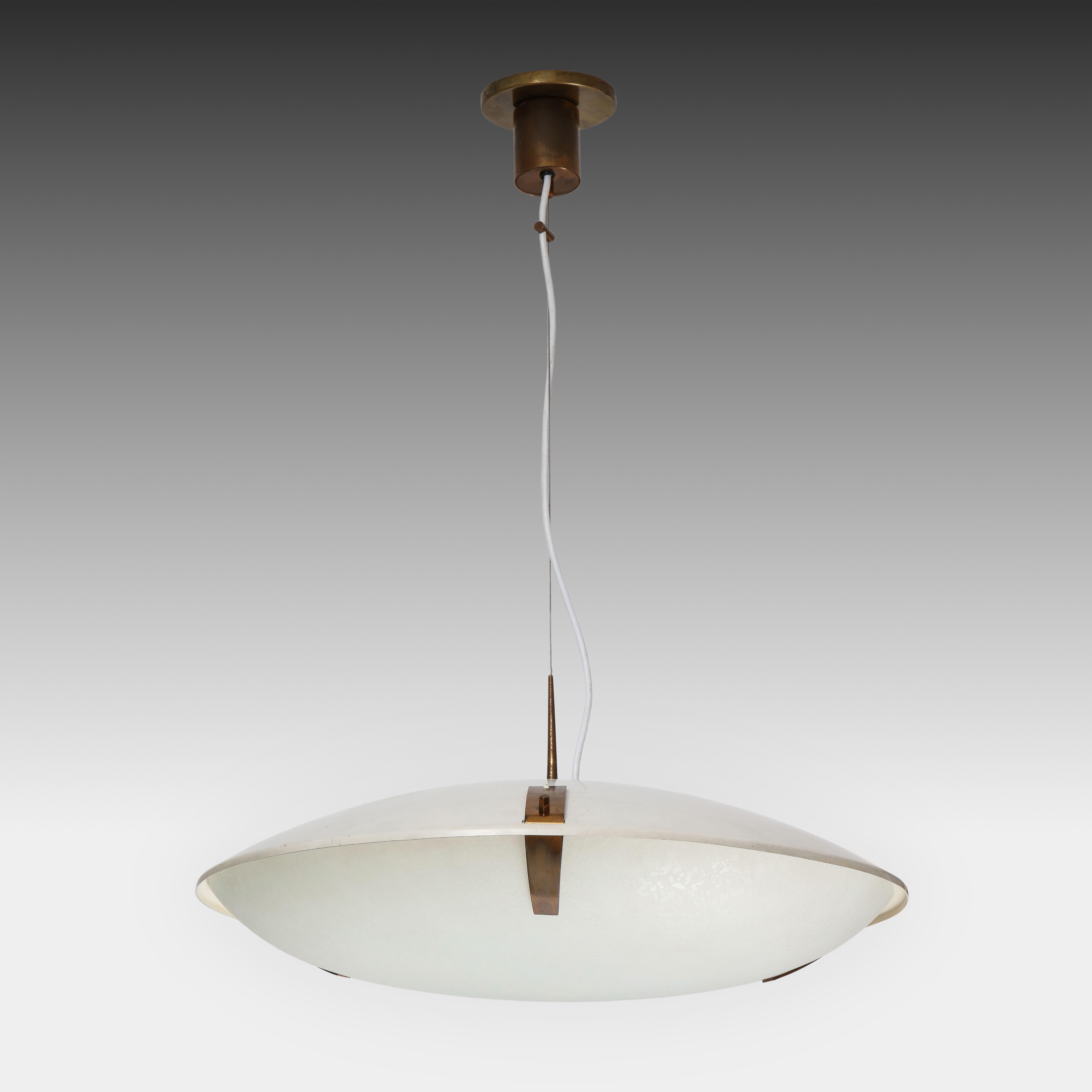 Stilnovo adjustable pendant or suspension light model 1140 with white enameled aluminum shade suspending textured glass dome shade with brass fittings and suspended from its original brass canopy with custom ceiling plate. Maximum adjustable height