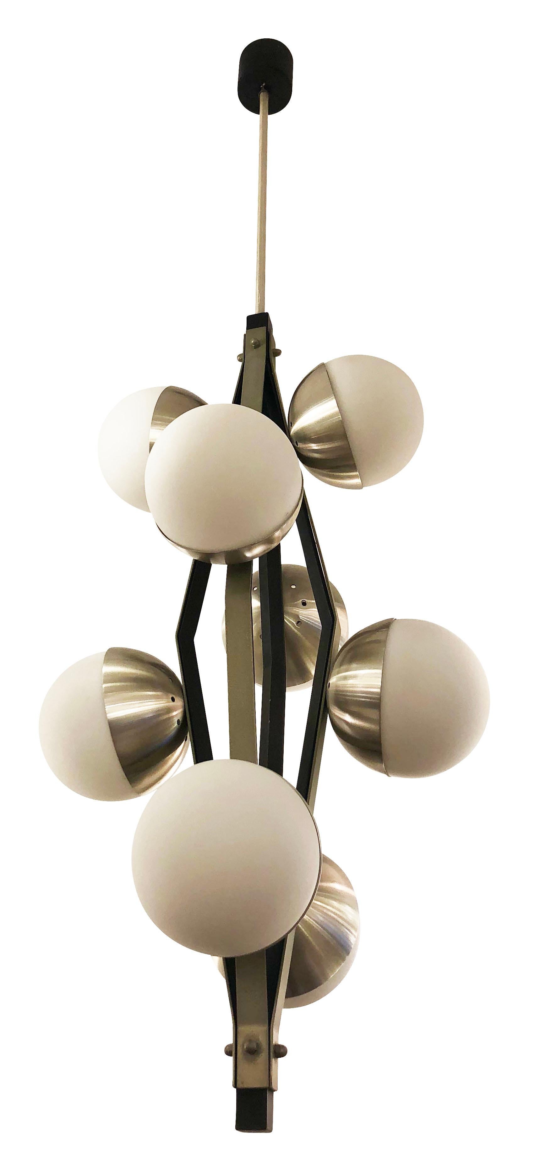Stilnovo pendant with eight frosted glass shades on a satin nickel and black lacquered frame. Holds eight candelabra sockets. Height of stem can be adjusted as needed.

Measures: Diameter 15”

Height 44”.

   