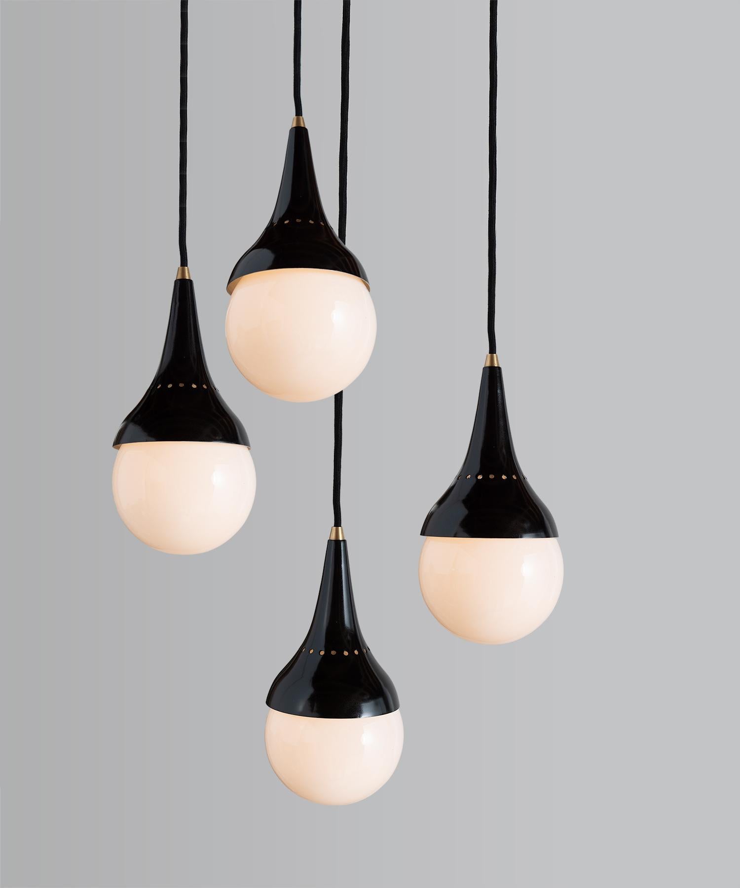 Stilnovo pendants, Italy, 1950.

Opal glass shade with black metal fitter and brass detailing.