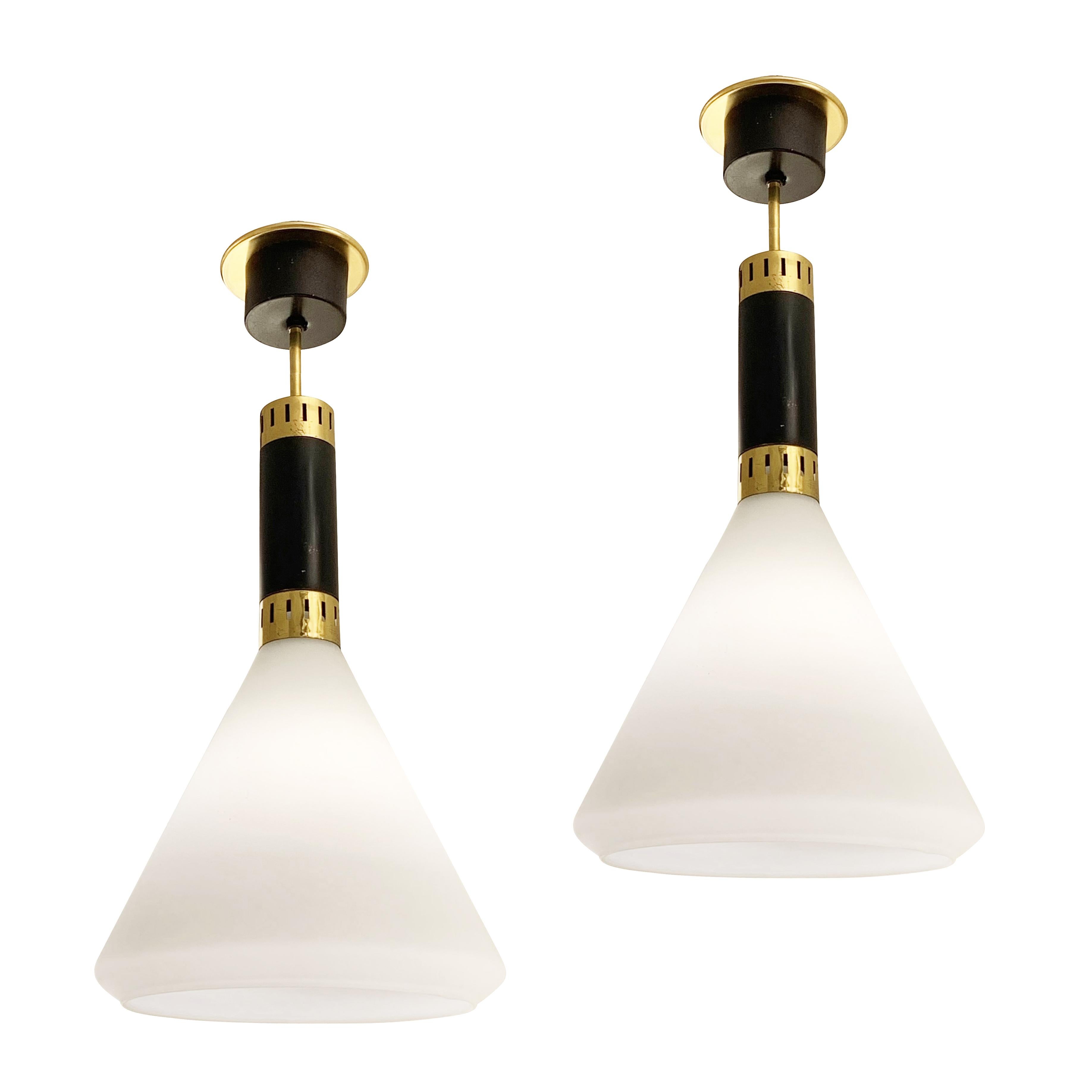 Italian Mid-Century pendants by Stilnovo. Frosted glass shades with brass and black lacquered hardware. Height of stem can be adjusted as needed. Each holds one E26 base bulb. Sold individually-price per light.

Condition: Excellent vintage