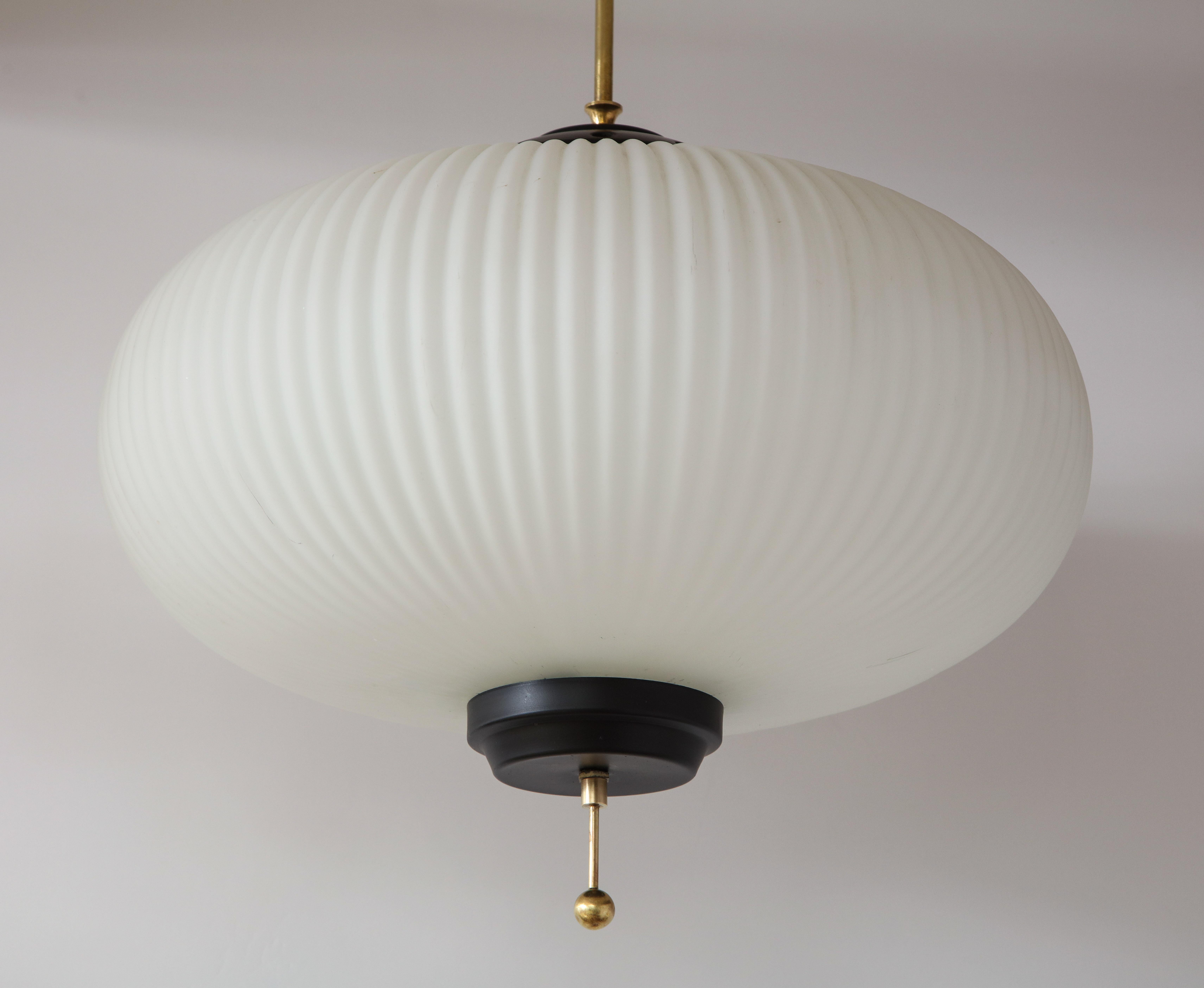 Stilnovo ribbed milk glass globe lantern/chandelier with lacquered black hardware and brass canopy and columnar support. A simple, elegant and timeless design. (Holds four standard sized light bulbs. Re-wired for USA Standards).
Italy, circa