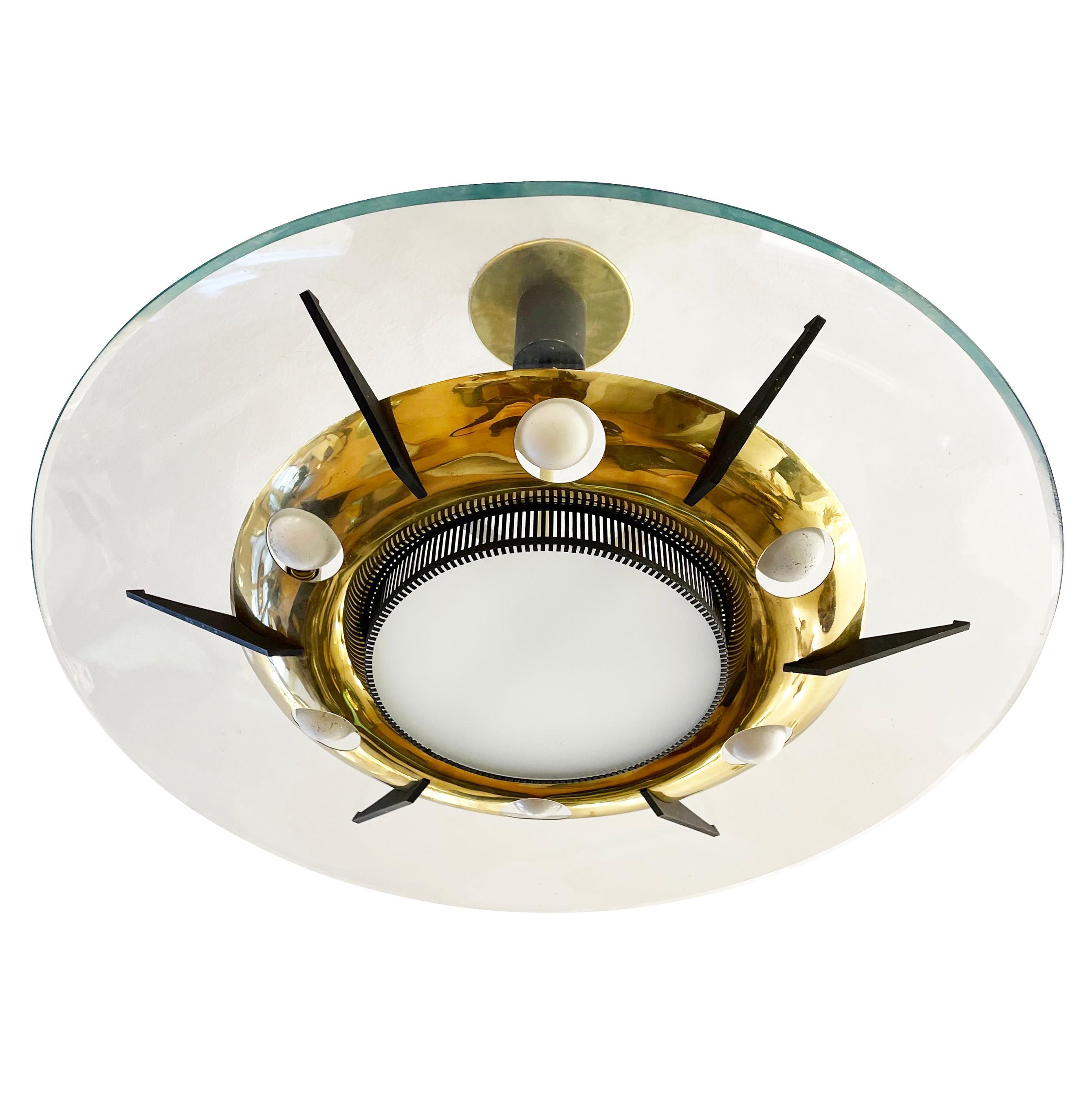 Italian midcentury chandelier by Stilnovo with a bras frame housing six light sources and a central frosted glass diffuser with an additional two light sources. Six supports protruding from the brass frame hold a large clear glass. Height of stem