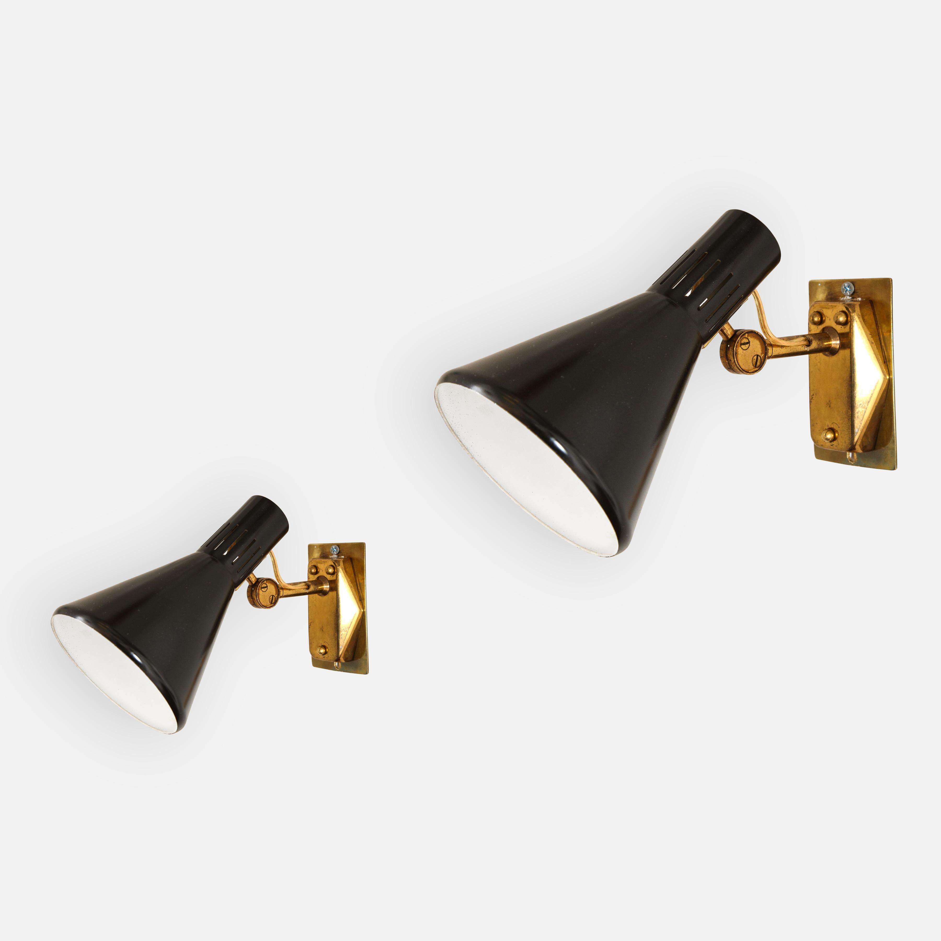 Stilnovo set of six articulating sconces model 2085 with black lacquered perforated metal shades which pivot vertically on brass arms attached to original backplates. Retains original manufacturers label marked STILNOVO. Recently restored and
