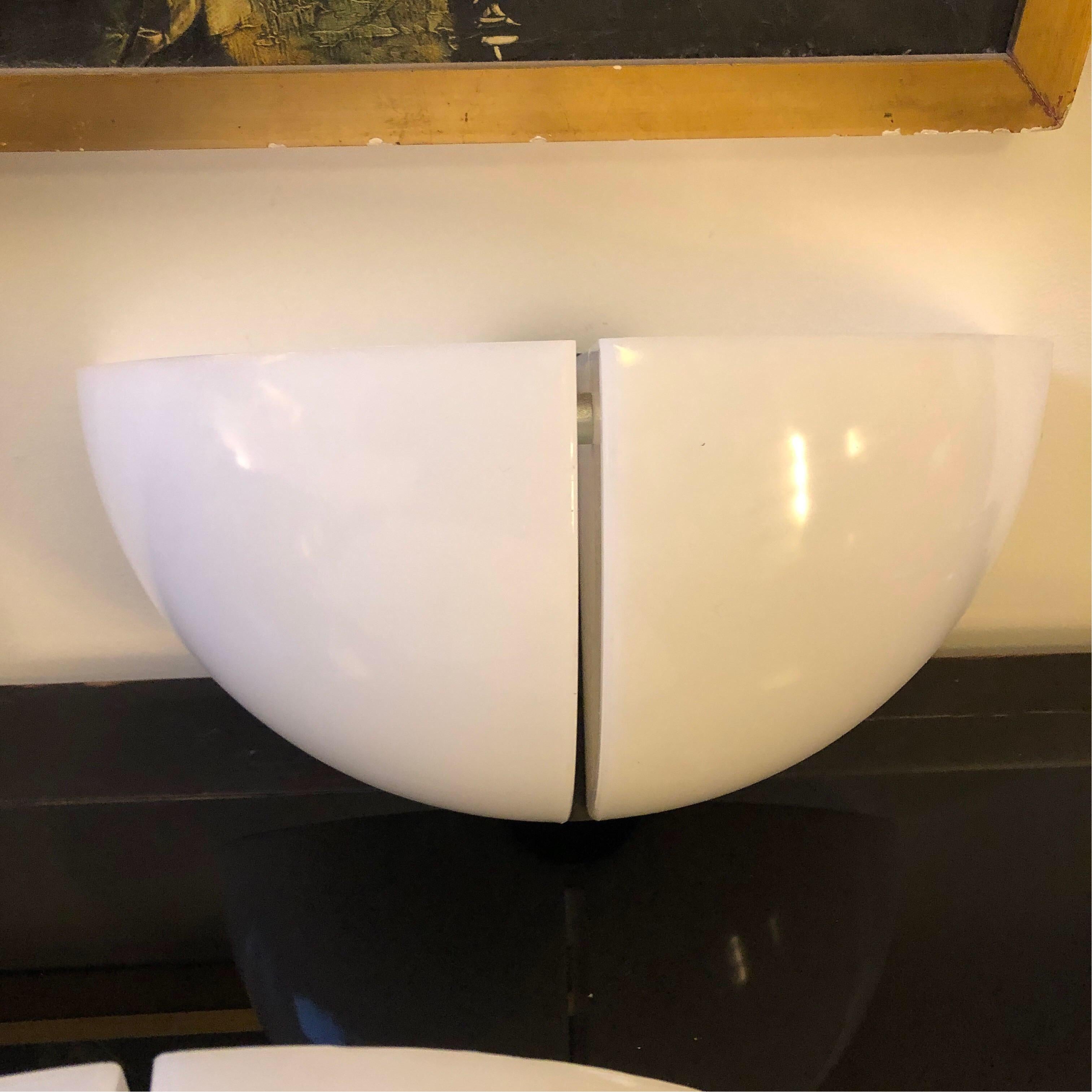 Two Stilnovo white plastic wall sconces made in Italy in the 1970s. They work 110-240 volts and need two regular e27 bulbs. Labeled and marked Stilnovo on the plastic.