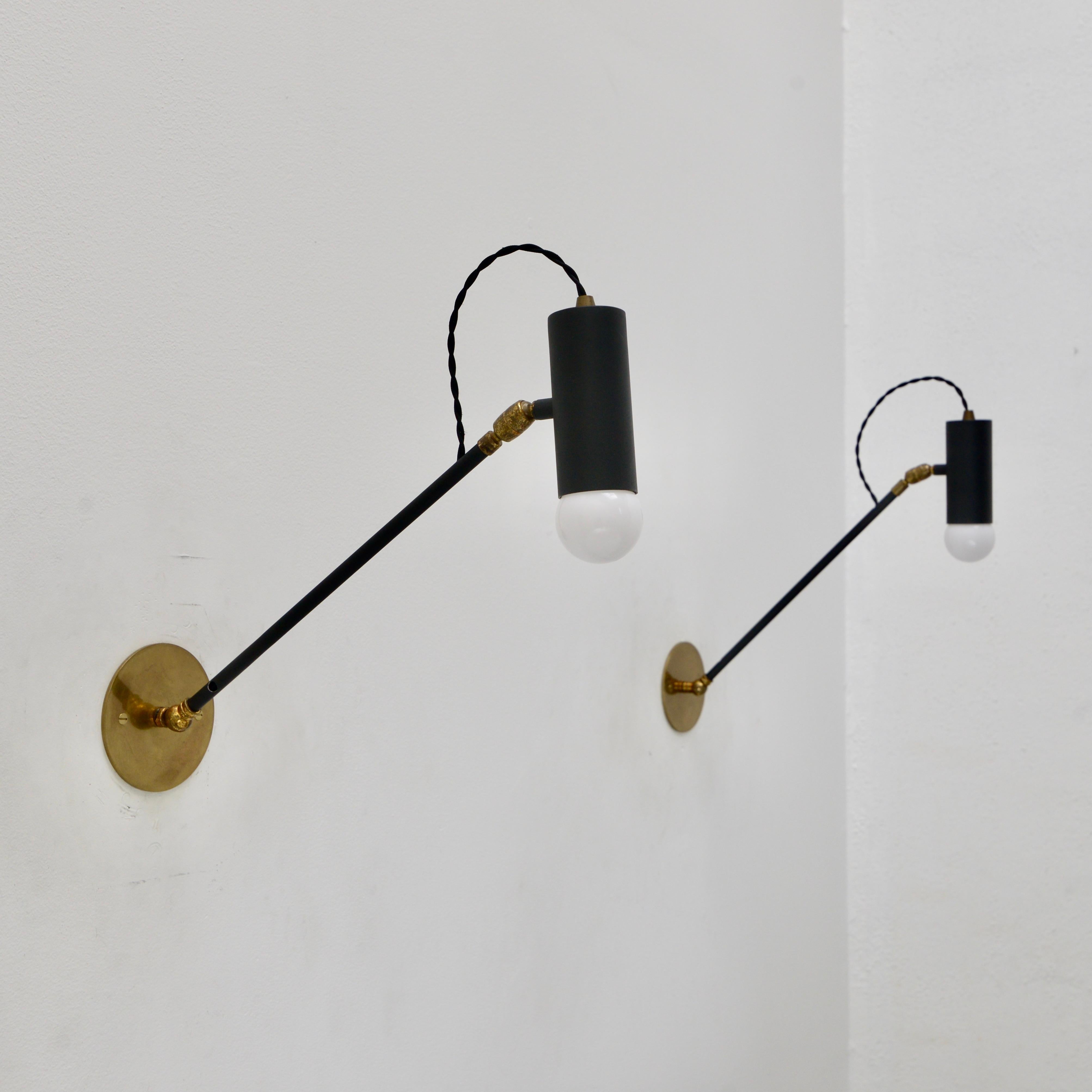 Elegant 1950s pair of Stilnovo Style spot reading sconces from Italy. The sconces project at the maximum 18” and articulate up and down. The shade joint articulates to allow the light to angle up, down, and side to side. The sconces are made from