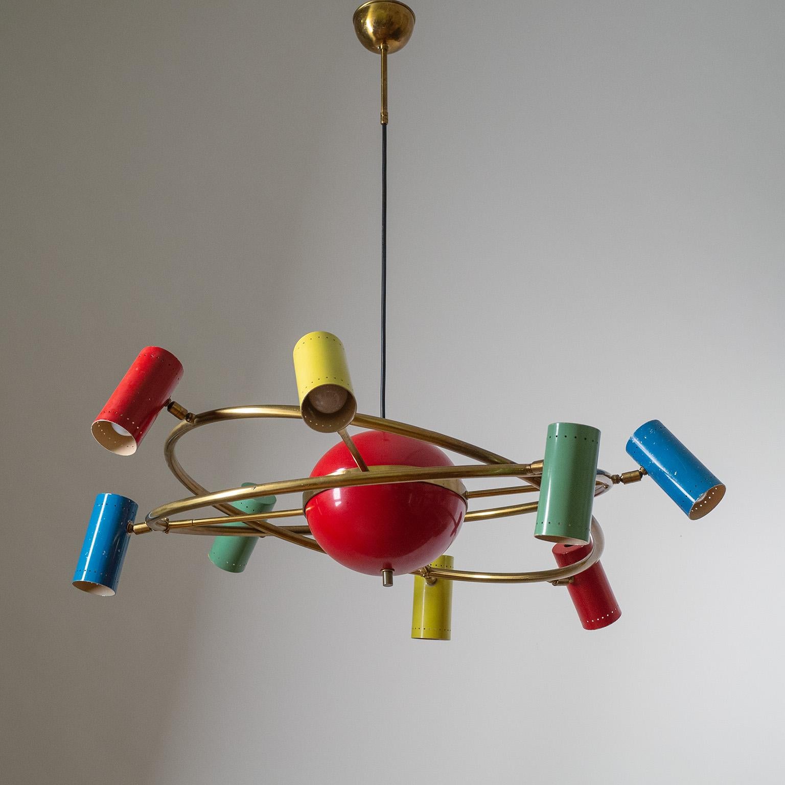 Rare Stilnovo Sputnik chandelier, circa 1960. Two large interlocked brass rings with eight lacquered cones 'orbiting' a large central globe. The colorful cones are attached by double-joints, allowing them to be positioned in multiple different ways,