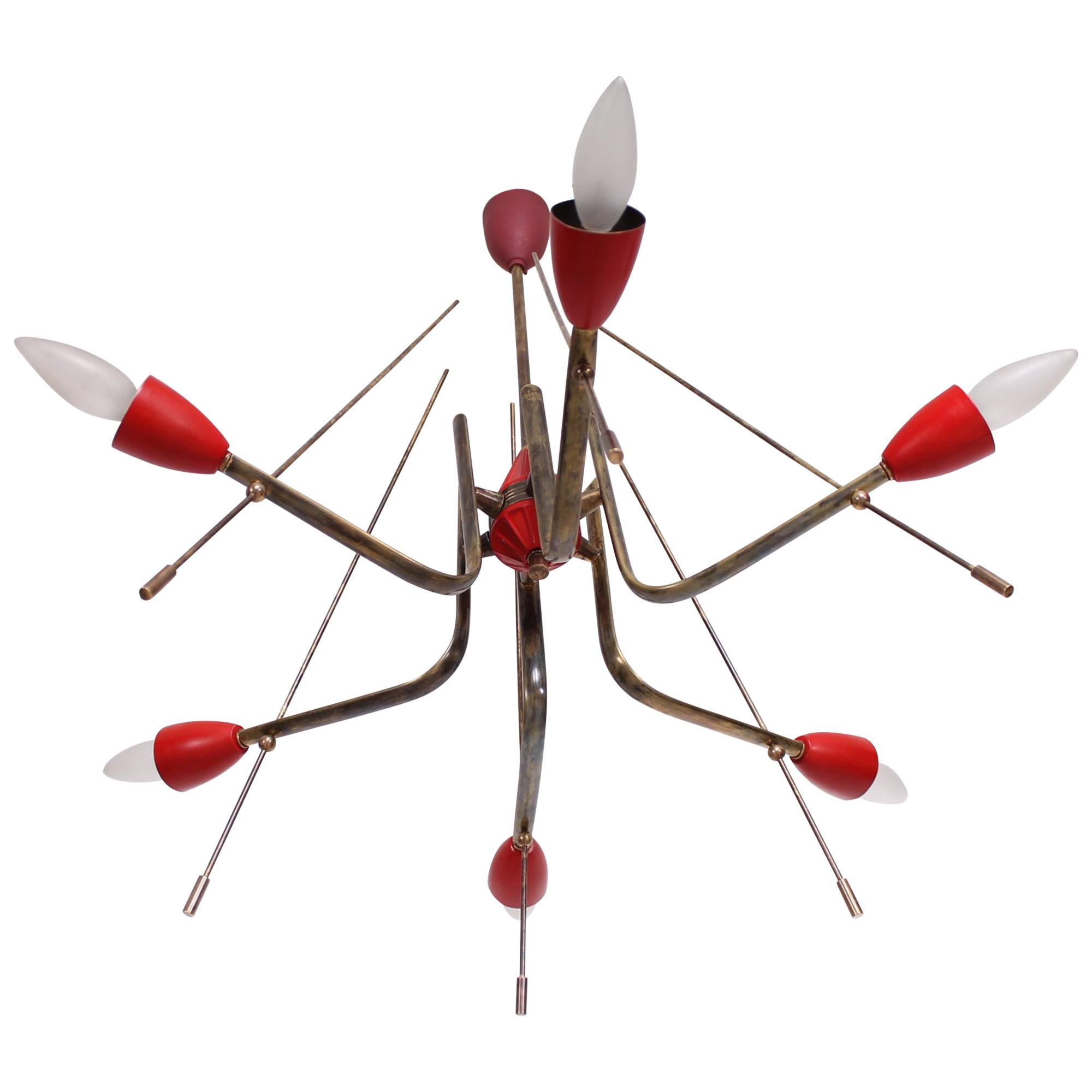 AMBIANIC presents
Atomic Age Futuristic Italian Red Chandelier 1950s ITALY
Constructed in Solid Brass with Aluminum Shades Painted RED.
Unmarked attributed style of Stilnovo.
21 .75 in diameter (without the bulbs) x 26 tall. 
Original vintage