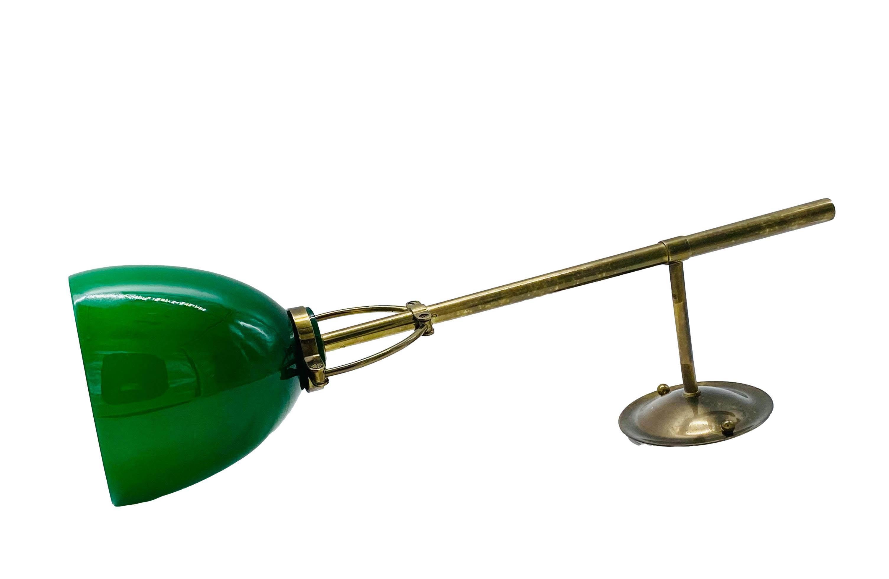 Wall lamp with green glass diffuser and opaline interior, it has a brass stem and a circular base. 
The lamp is made in Italy and dates from the 1950's. 
It can be used as a wall light, picture and art light or vertically as a desk light. Rewired,