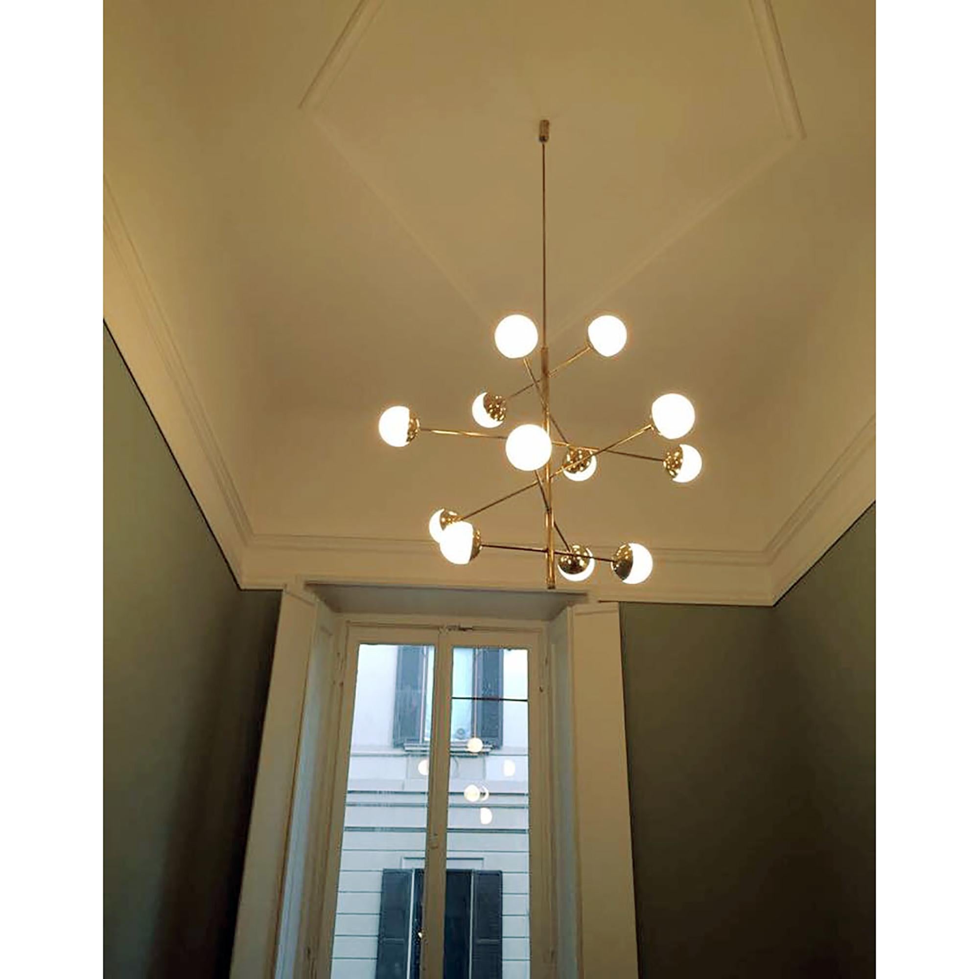 Inspired by the Stilnovo's Italian Mid-Century Modern designs, this chandelier will bring an amazing accent to your interior. The arms radiate diametric all around the stem, each ending with an opaline glass globe. An important architectural ceiling