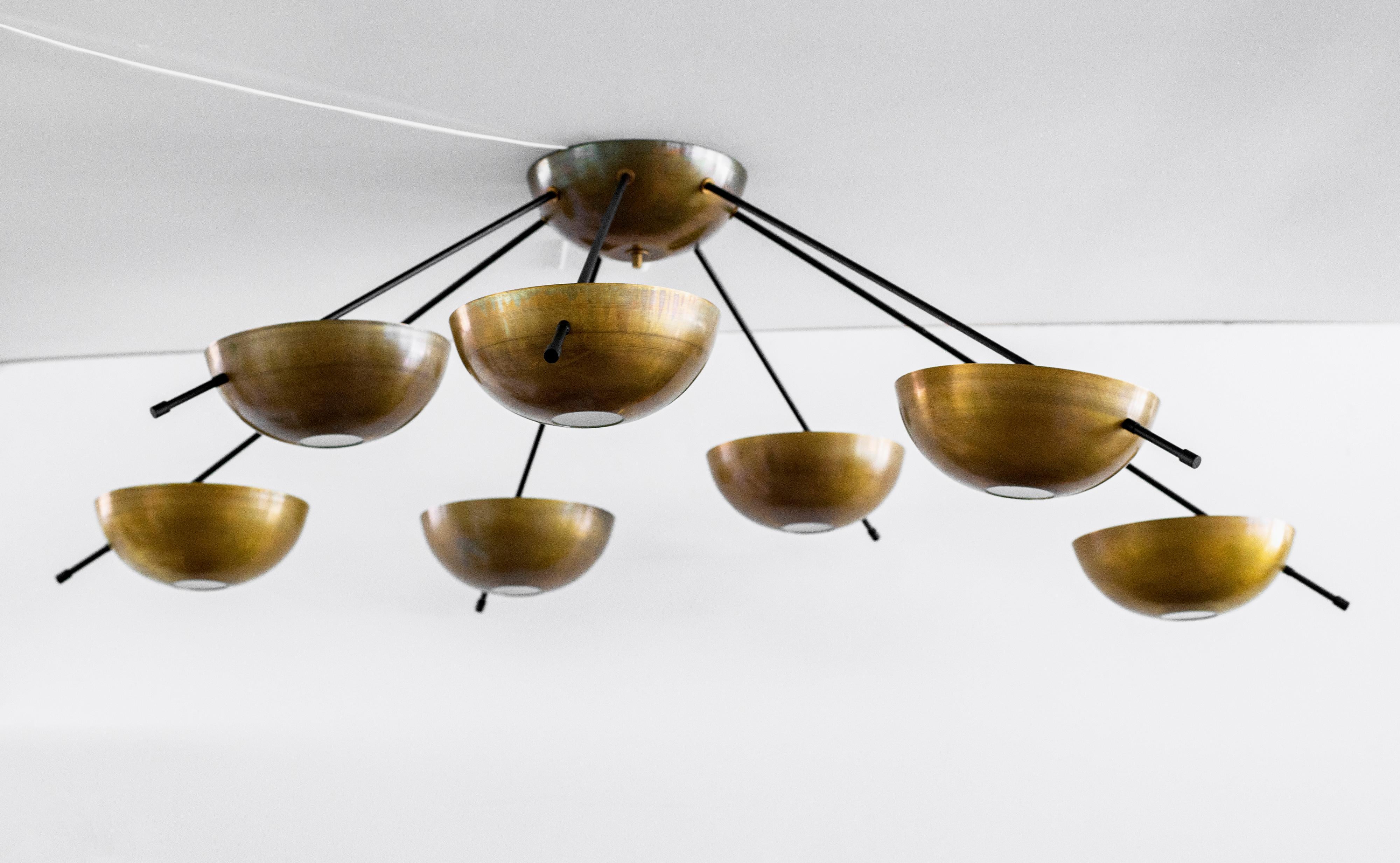 Incredible Italian ceiling light with 7 solid brass dome cups floating on thin black metal arms. Illuminates beautifully. Newly produced in Italy, wired to American standards.