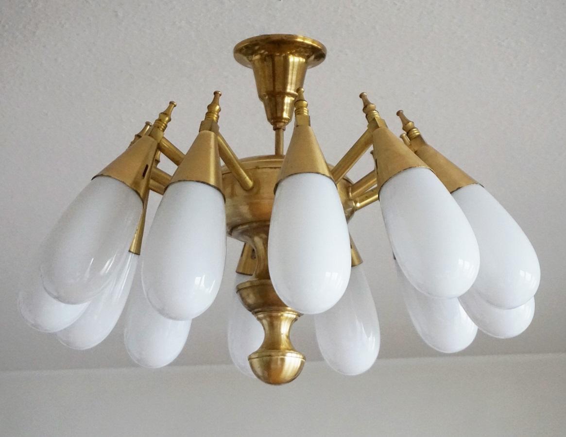 A Stilnovo style polished brass twelve-arm flush mount with hand blown opaline glass globes, Italy, 1960-1969, impressive lighting effect! In perfect vintage condition and fully working.
It takes twelve Edison E-14 screw bulbs.
Measures:
Diameter